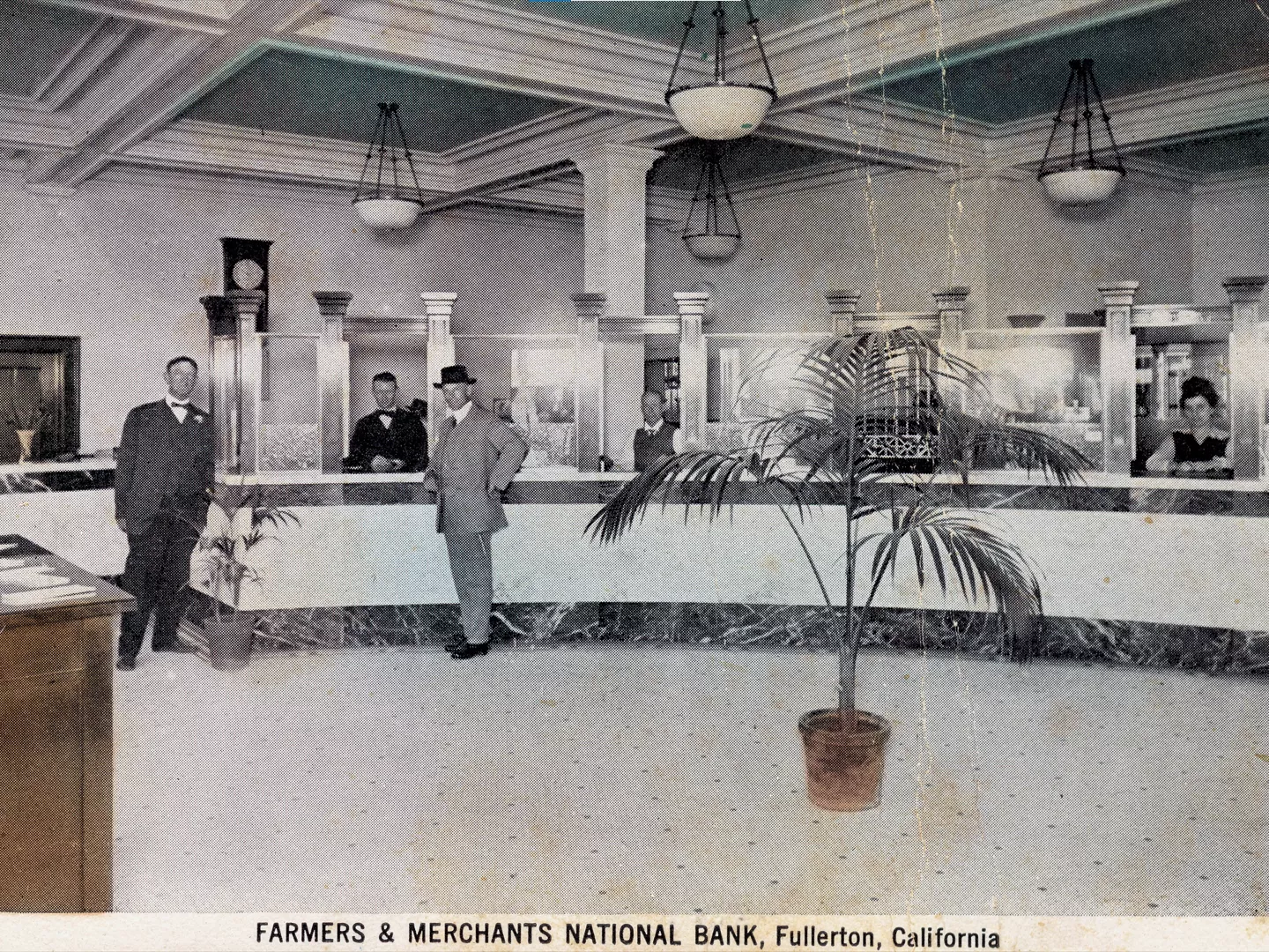 A colored photo of the interior of the Farmers and Merchants Bank. The bottom of the photo reads: FARMERS &amp; MERCHANTS NATIONAL BANK, Fullerton, California.