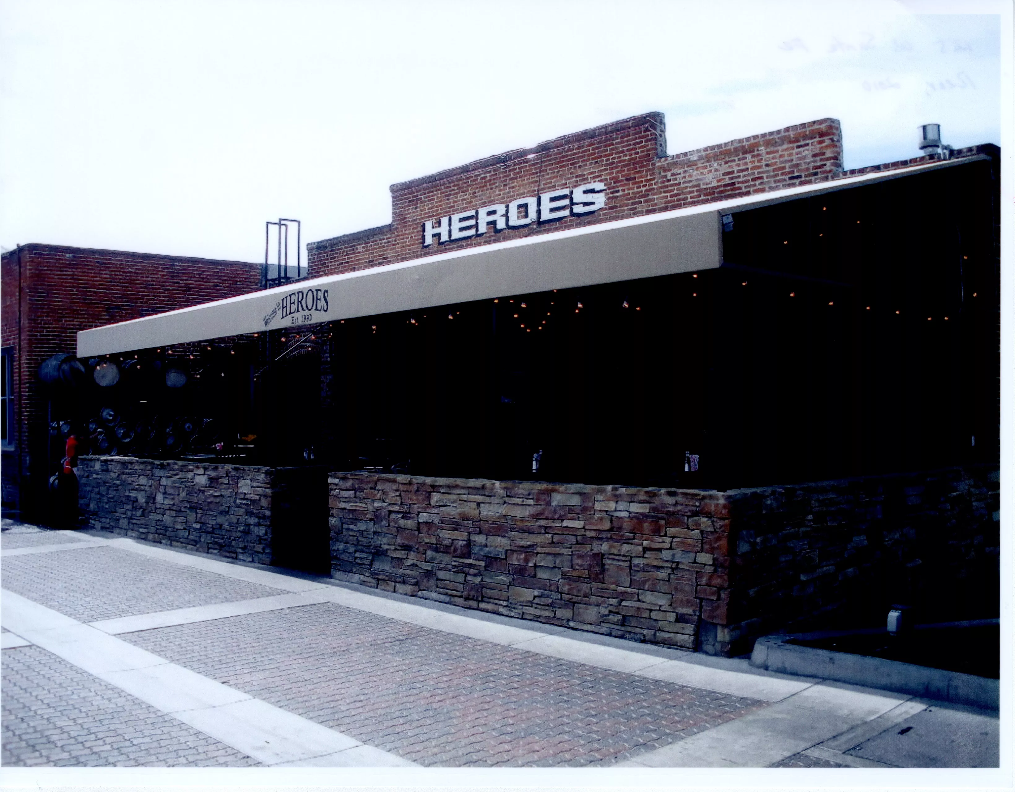 A colored photo of the rear exterior of the John Reeder Gardiner Building (now Heroes Bar &amp; Grill) in 2012.