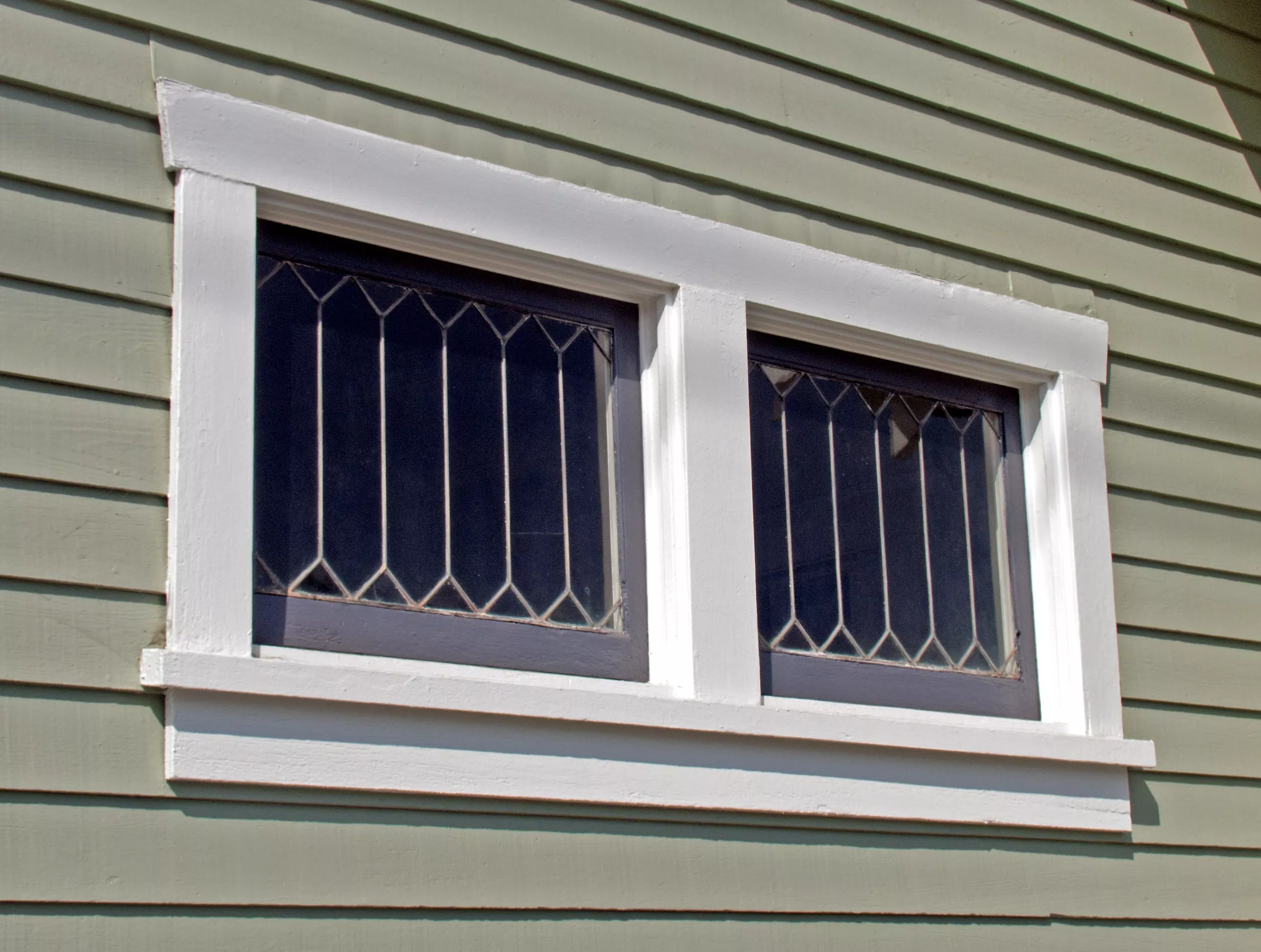 A colored photo of the window detail of the Henry Burdorf House in 2012.