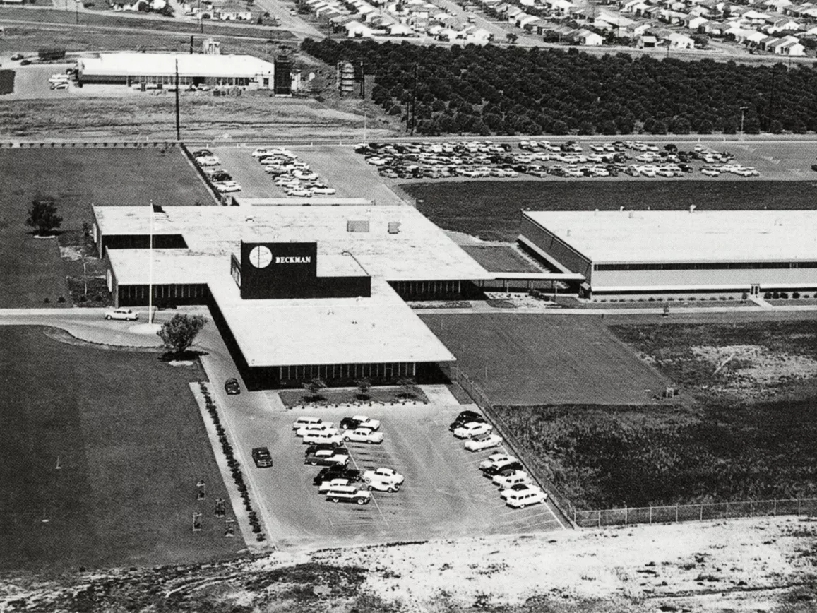 A black and white aerial view photograph of the Beckman Instruments Administration Building.