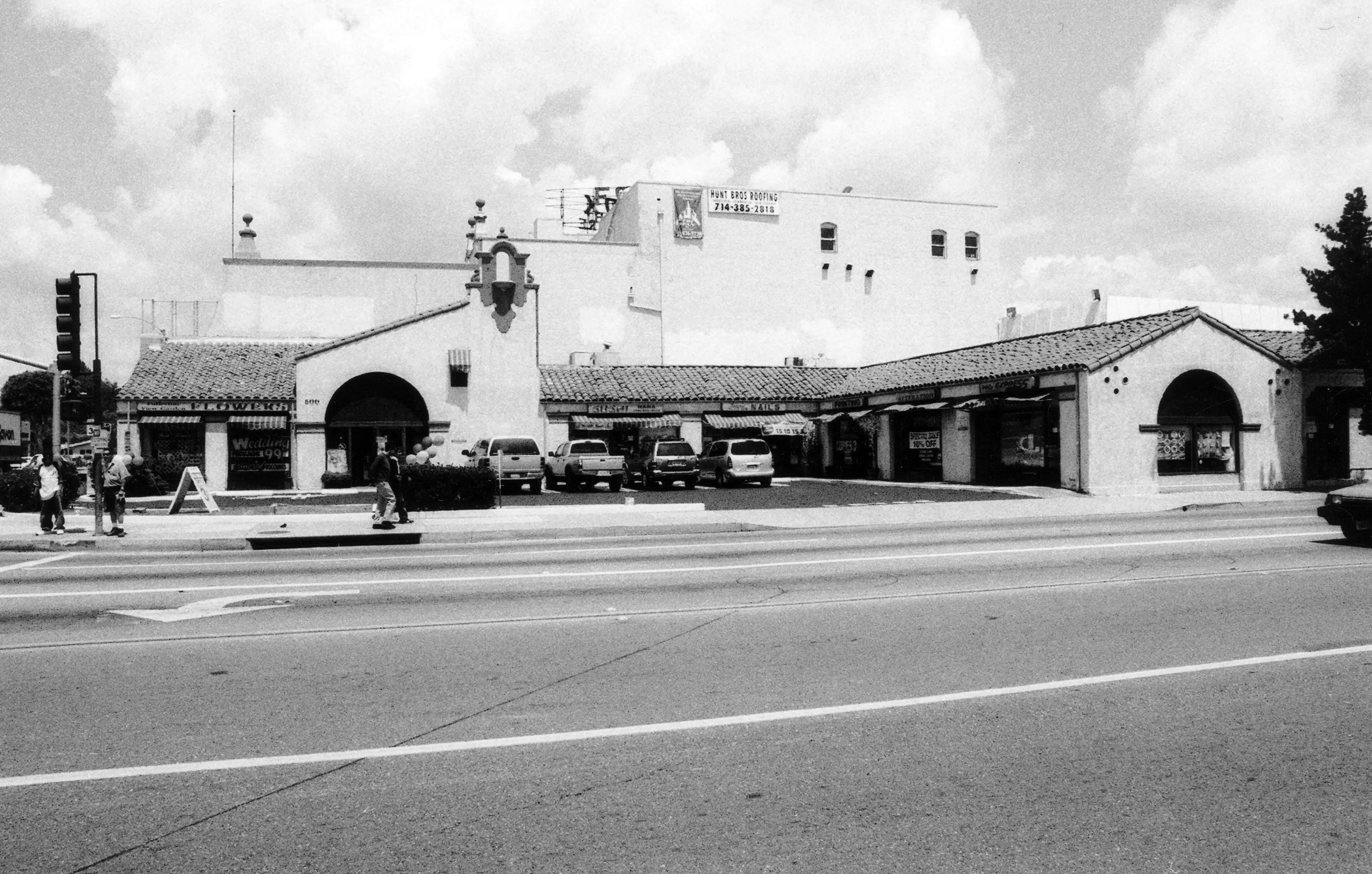 A black and white photograph of the Firestone Tire Service Building as a retail space in 2005.