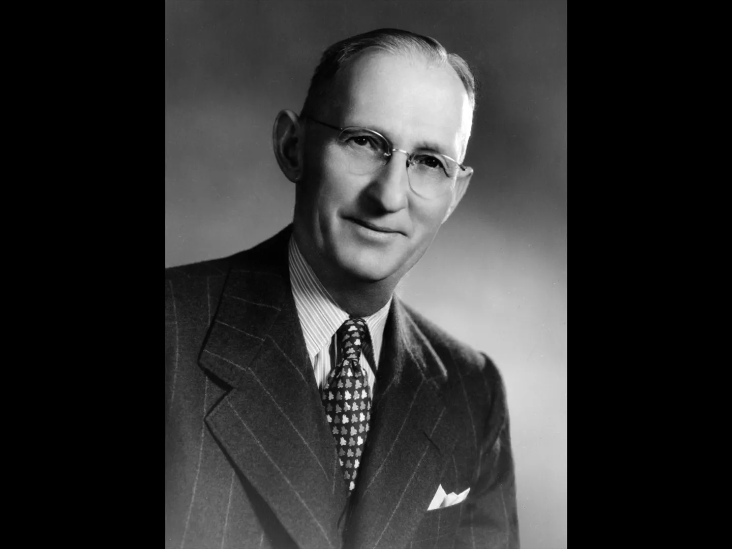 A black and white portrait photograph of Clarence Spencer.