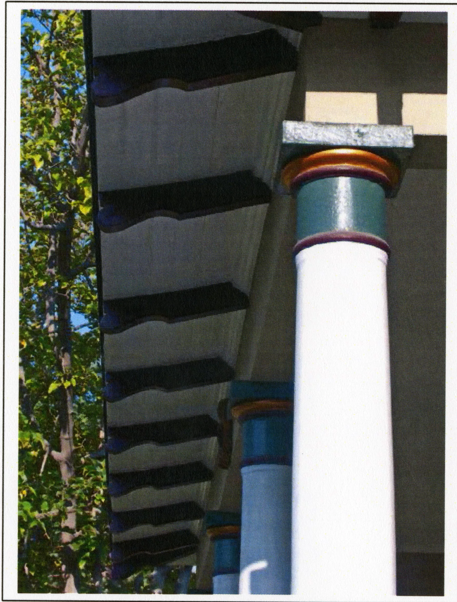 A colored photo of the column and eave detailing of the Herman Russell House in 2015.