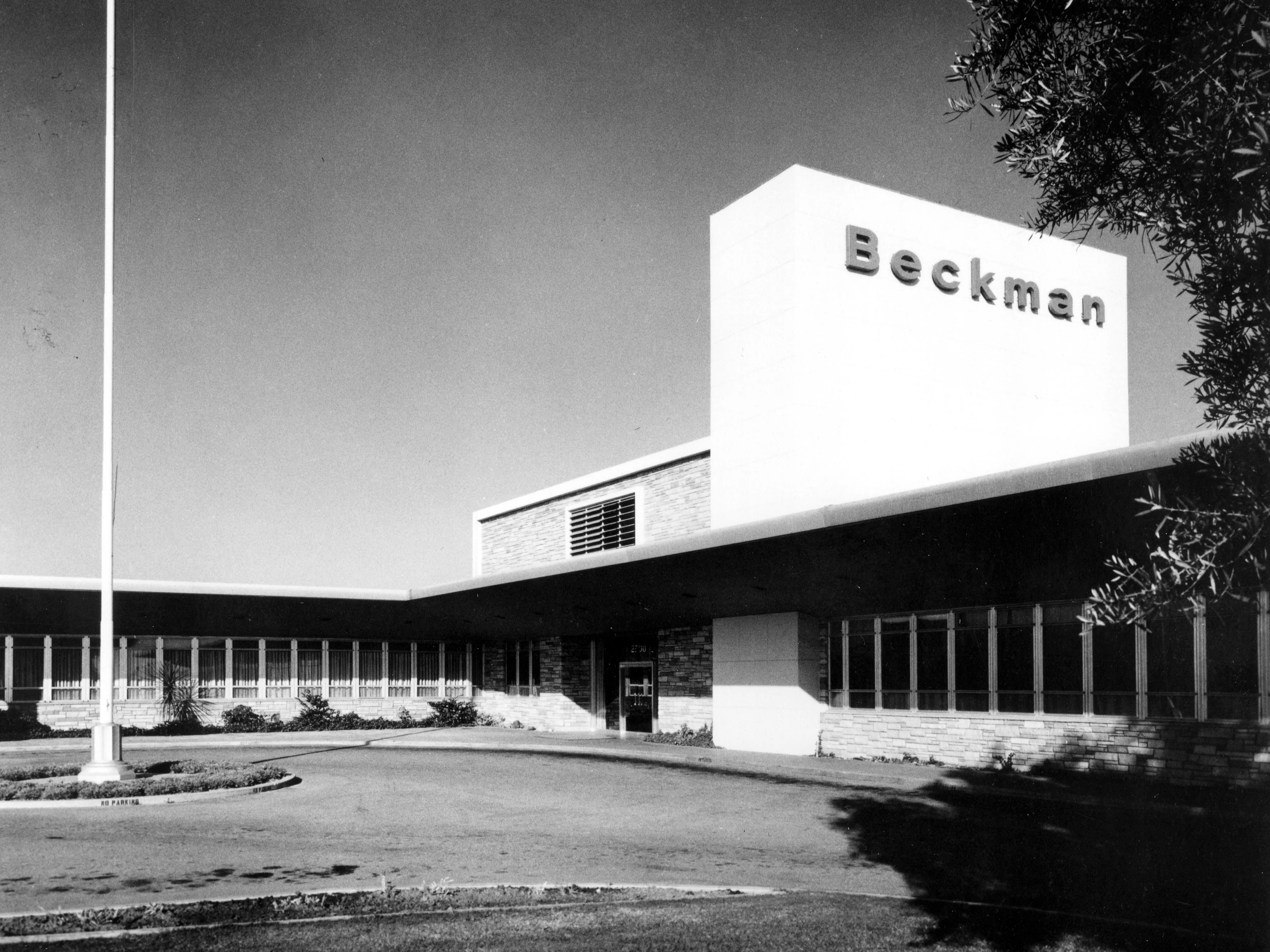 A black and white photograph of the exterior of the admin offices for the Beckman Instruments Administration Building.
