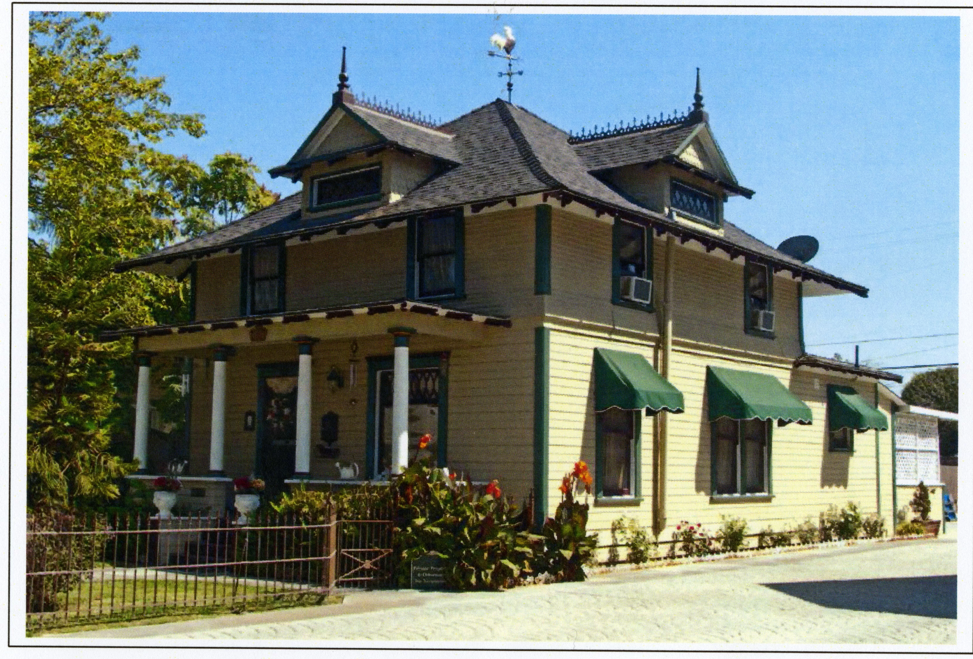 A colored photo of the northwest exterior of the Herman Russell House in 2015.