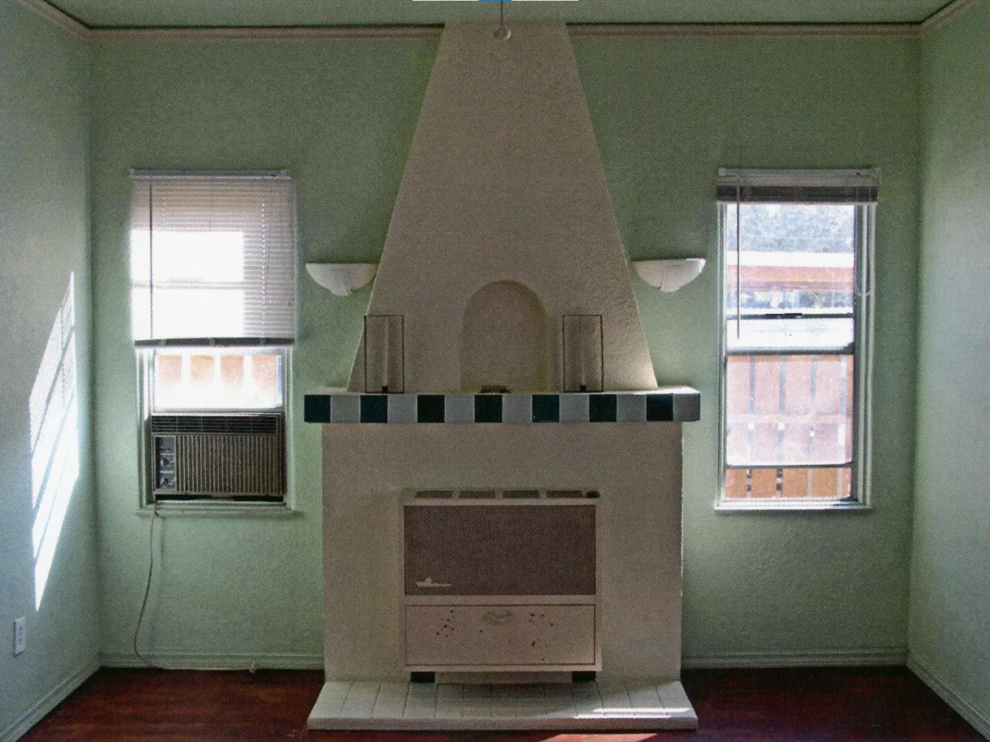 A colored photo of the false fireplace inside the Fred Carter Apartment House in 2014.