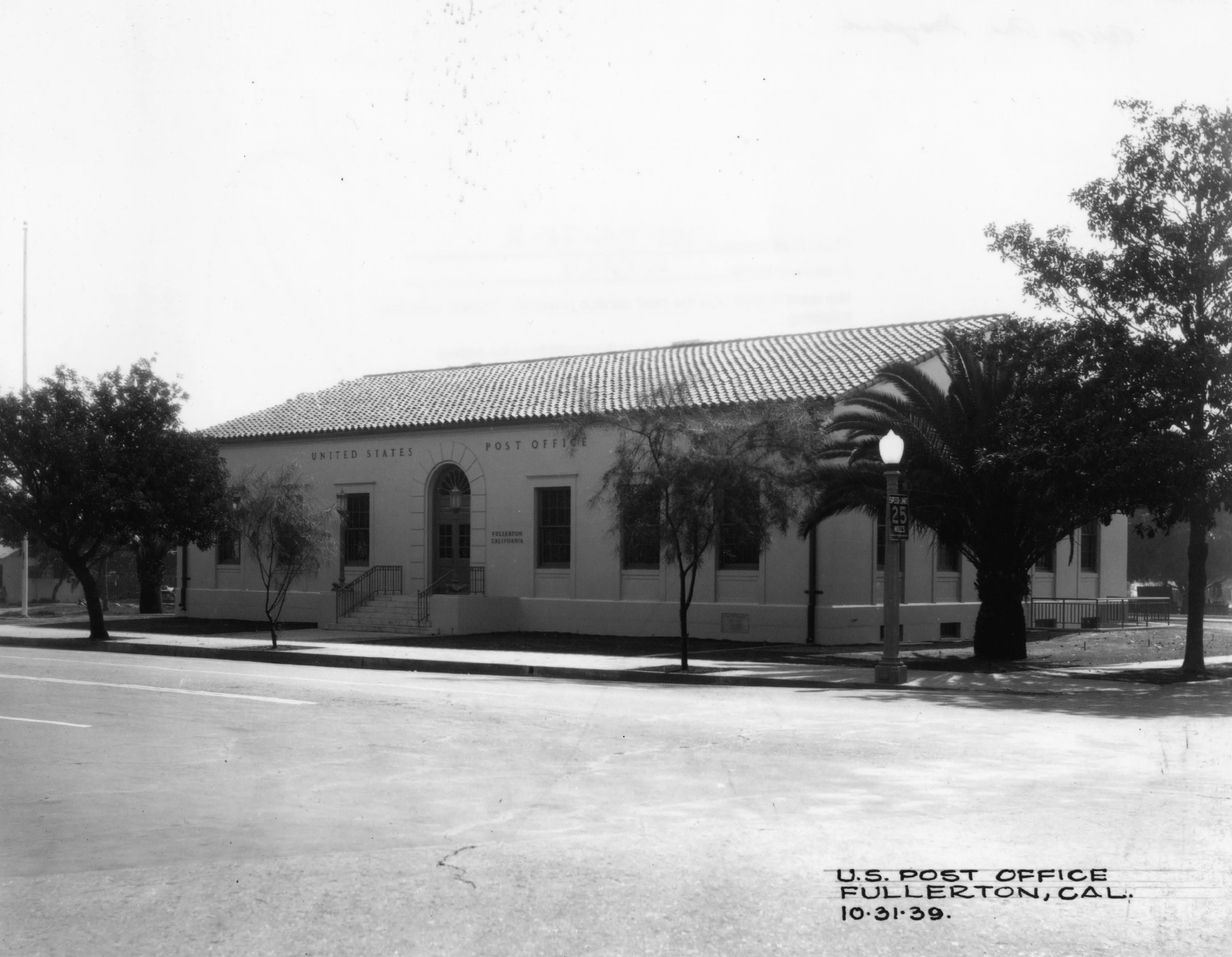 A black and white photograph of the front exterior of the Commonwealth Post Office in 1939. The bottom right corner of the photo reads: U.S. Post Office. Fullerton, California. October 31, 1939.