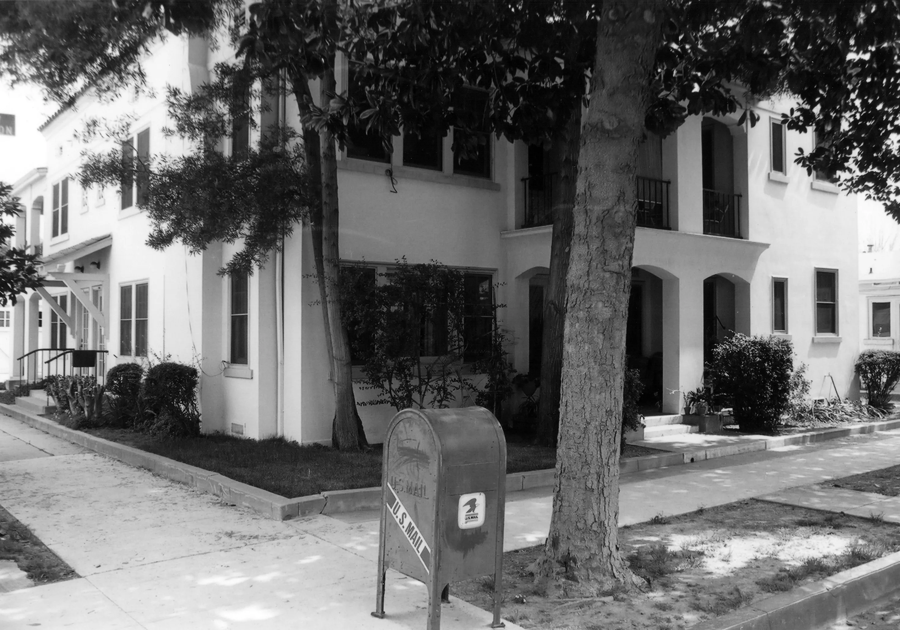 A black and white photograph of the Pomona Apartments for the Historical Building Survey in 1978.