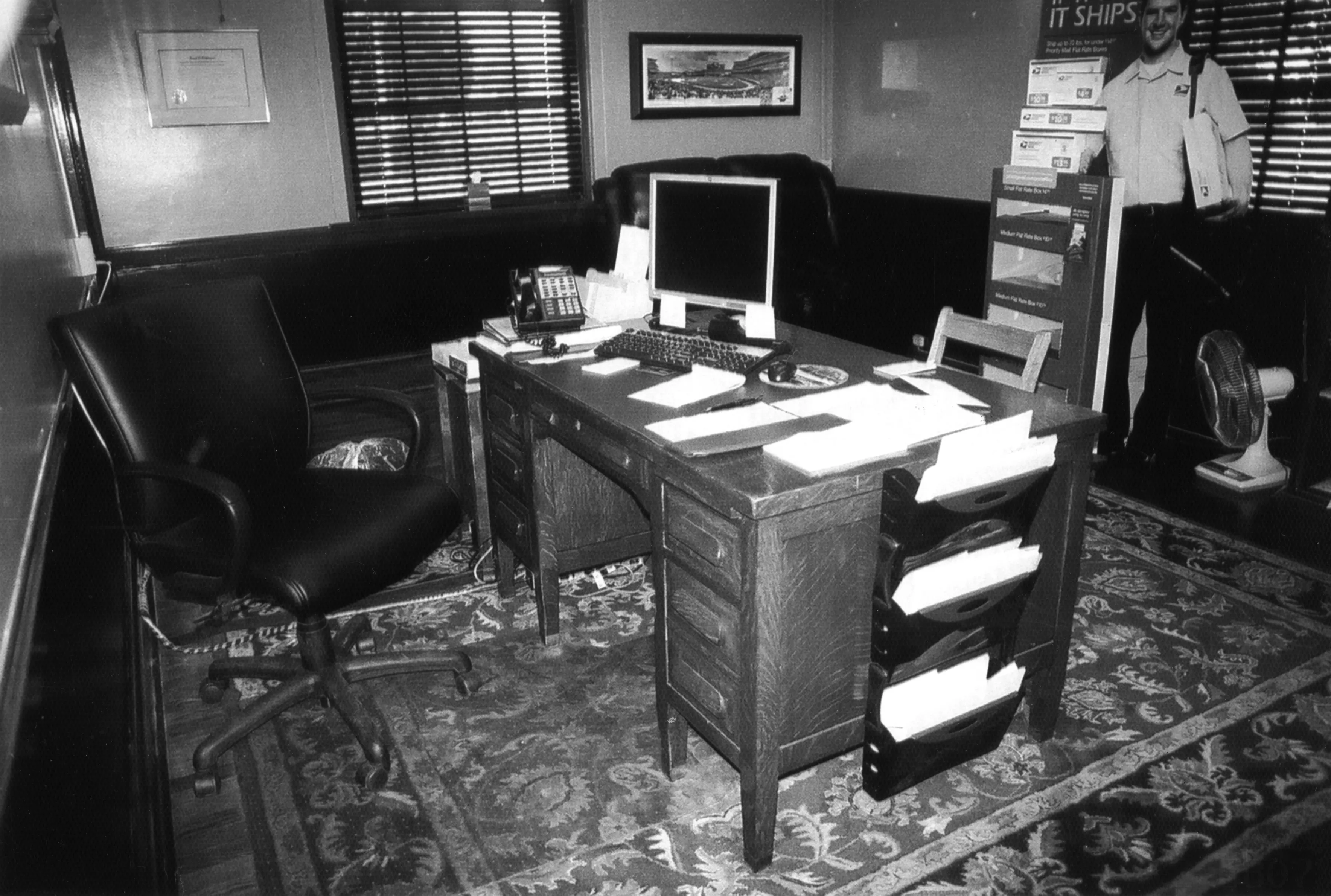 A black and white photograph of the interior office inside the Commonwealth Post Office in 2010.