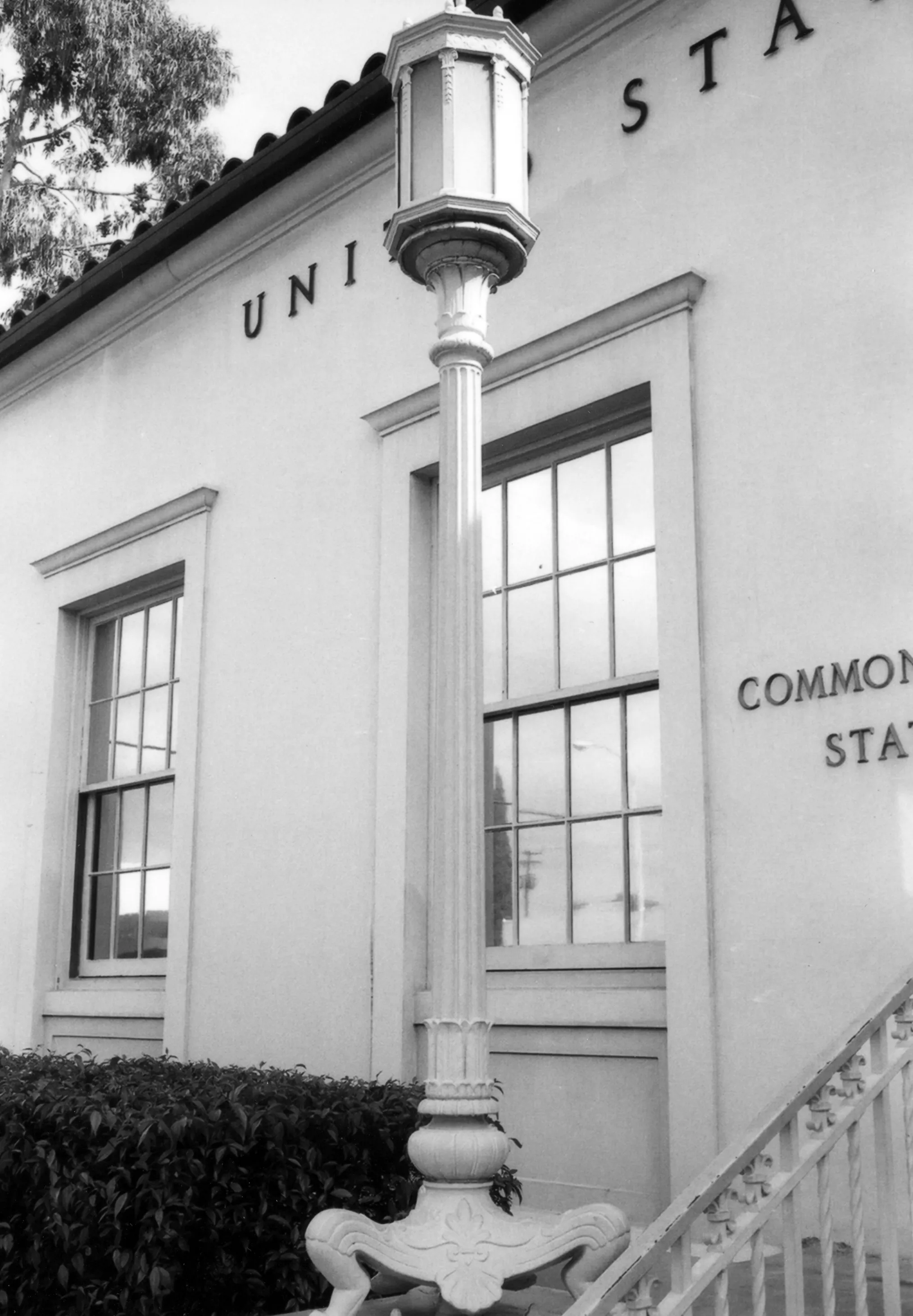 A black and white photograph of a light fixture outside the Commonwealth Post Office in 1978.