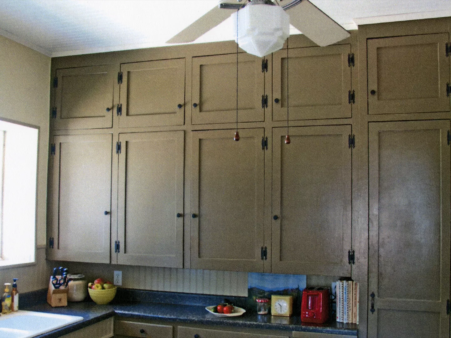 A colored photo of the original cabinetry in the kitchen of the Julius Bradford House in 2013.