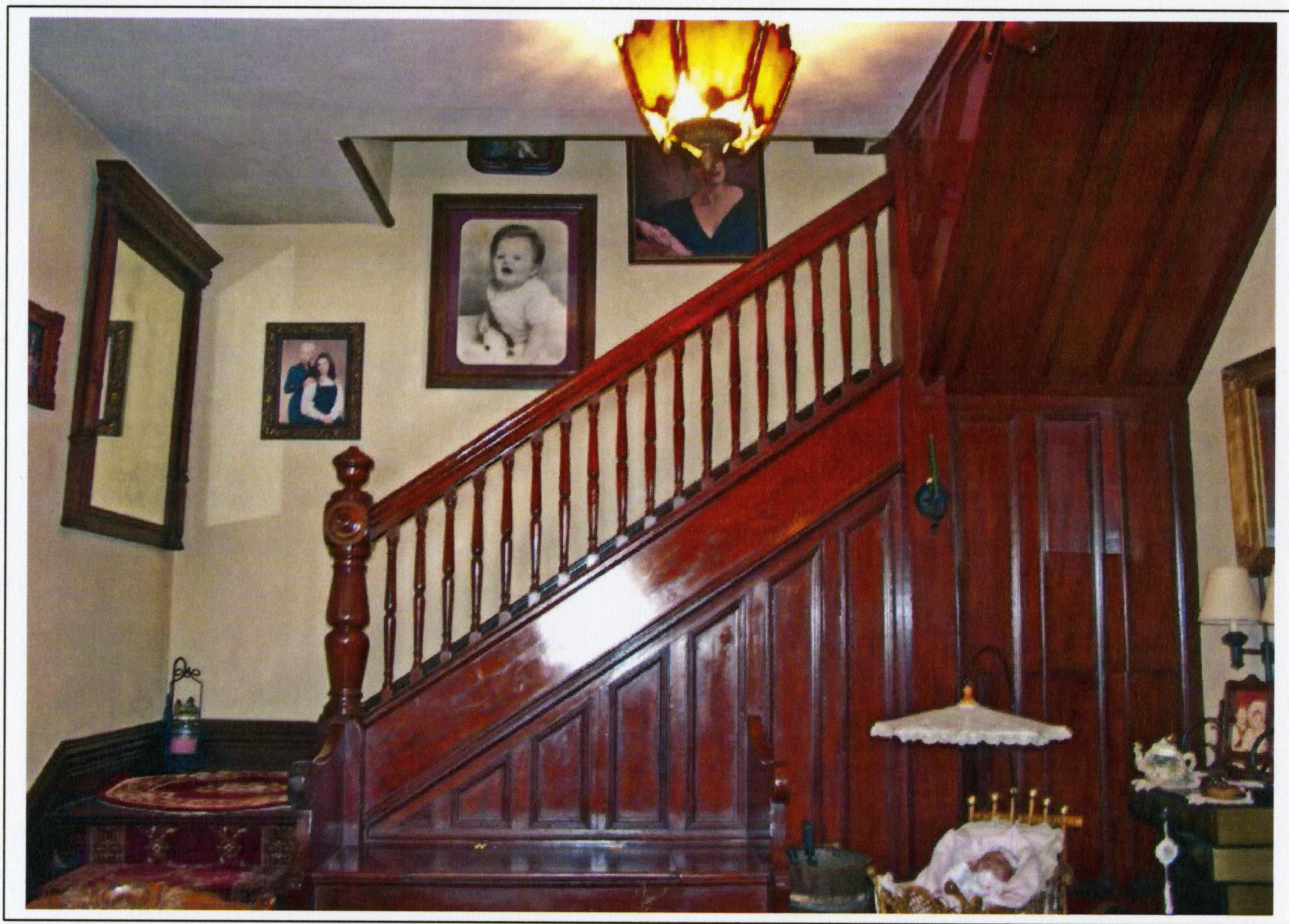 A colored photo of the original staircase inside the Herman Russell House in 2015.