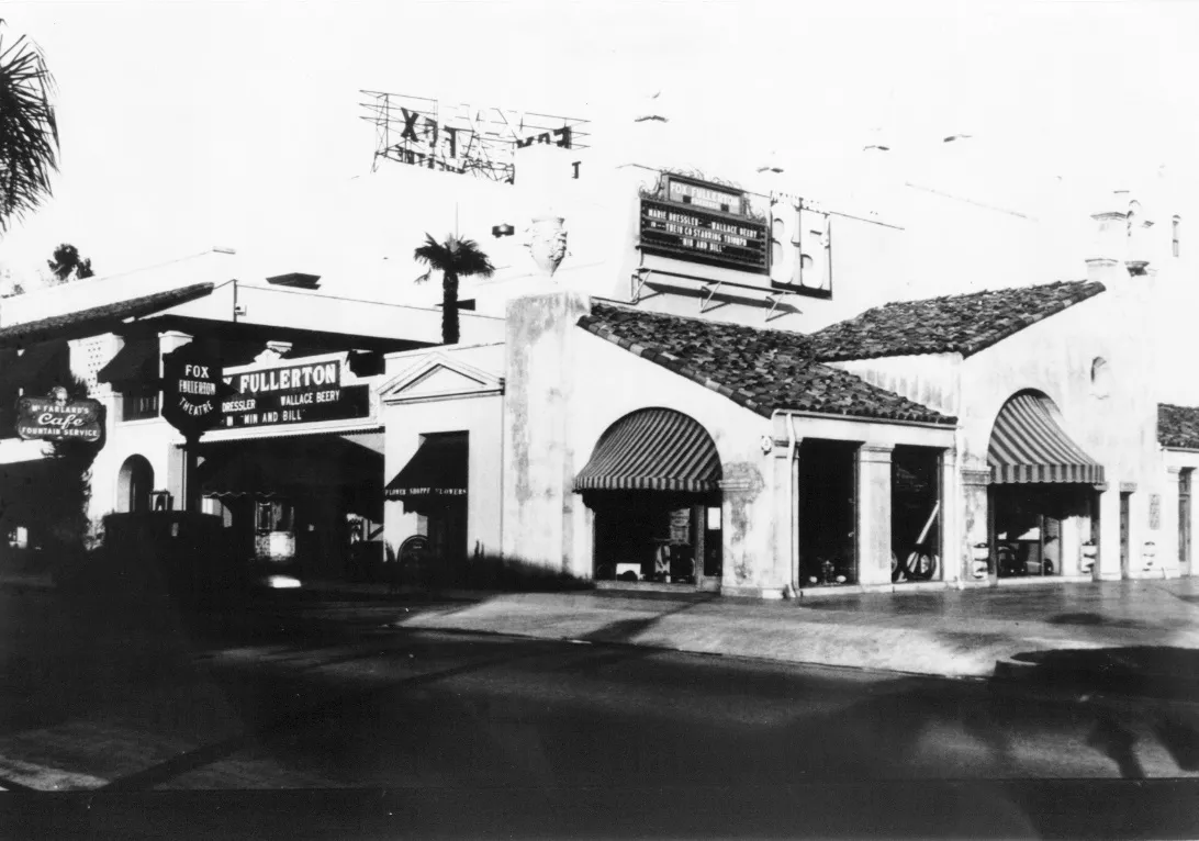 A black and white photograph of the partial exterior of the Firestone Tire Service Building in 1930.