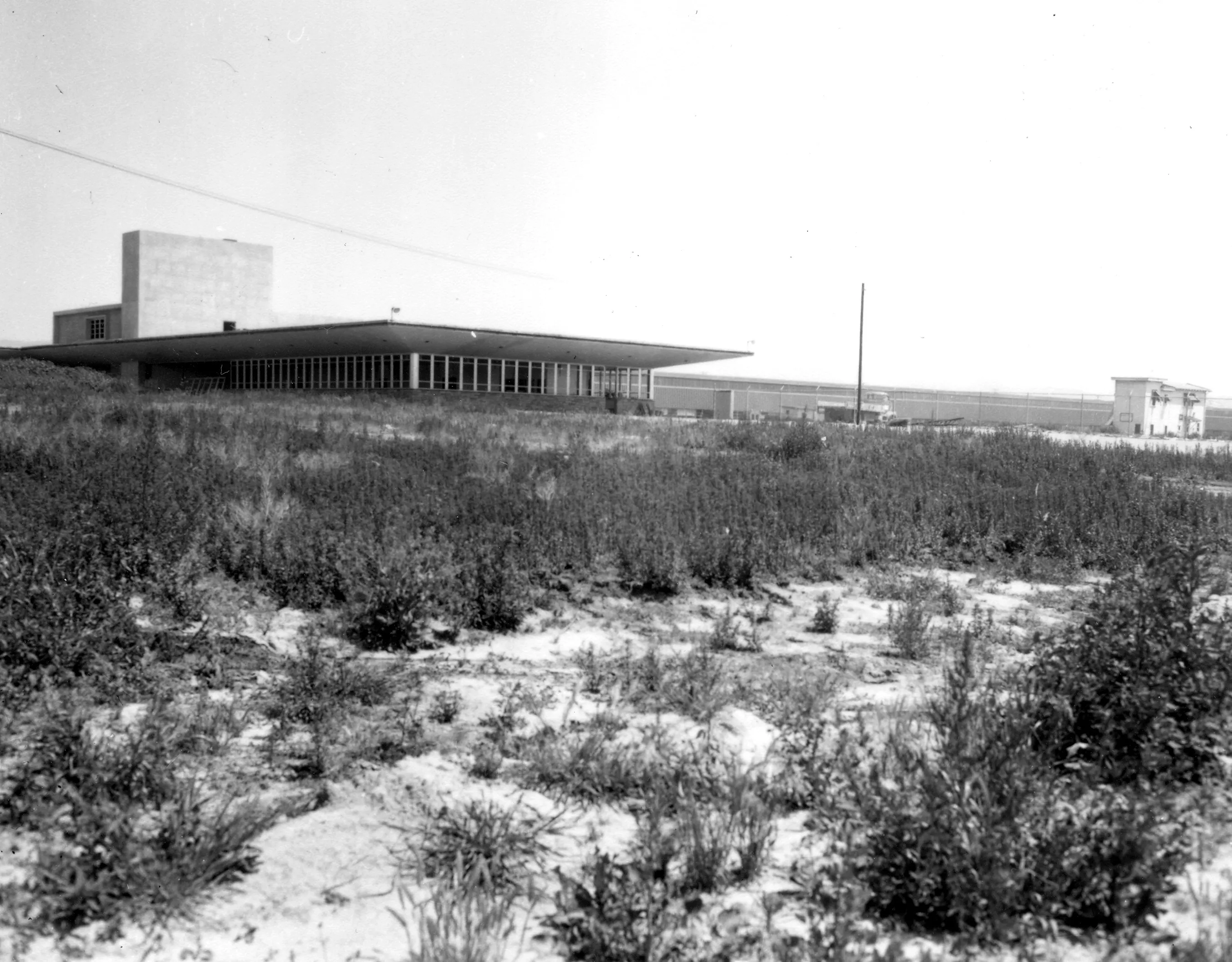 A black and white photograph of the rear of the Beckman Instruments Administration Building property.