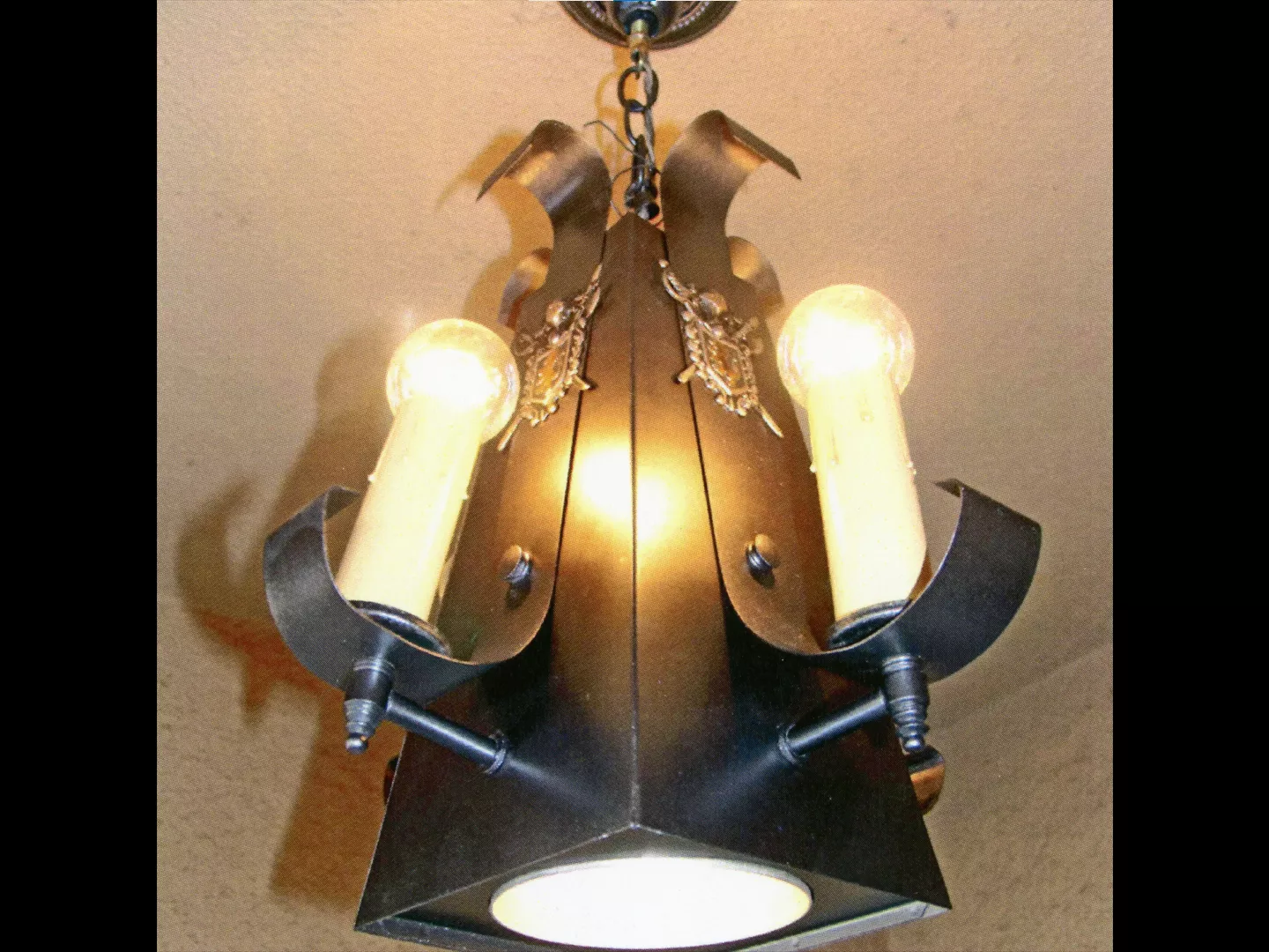 A colored photo of the restored original porch light for the Fred Carter Apartment House in 2014.