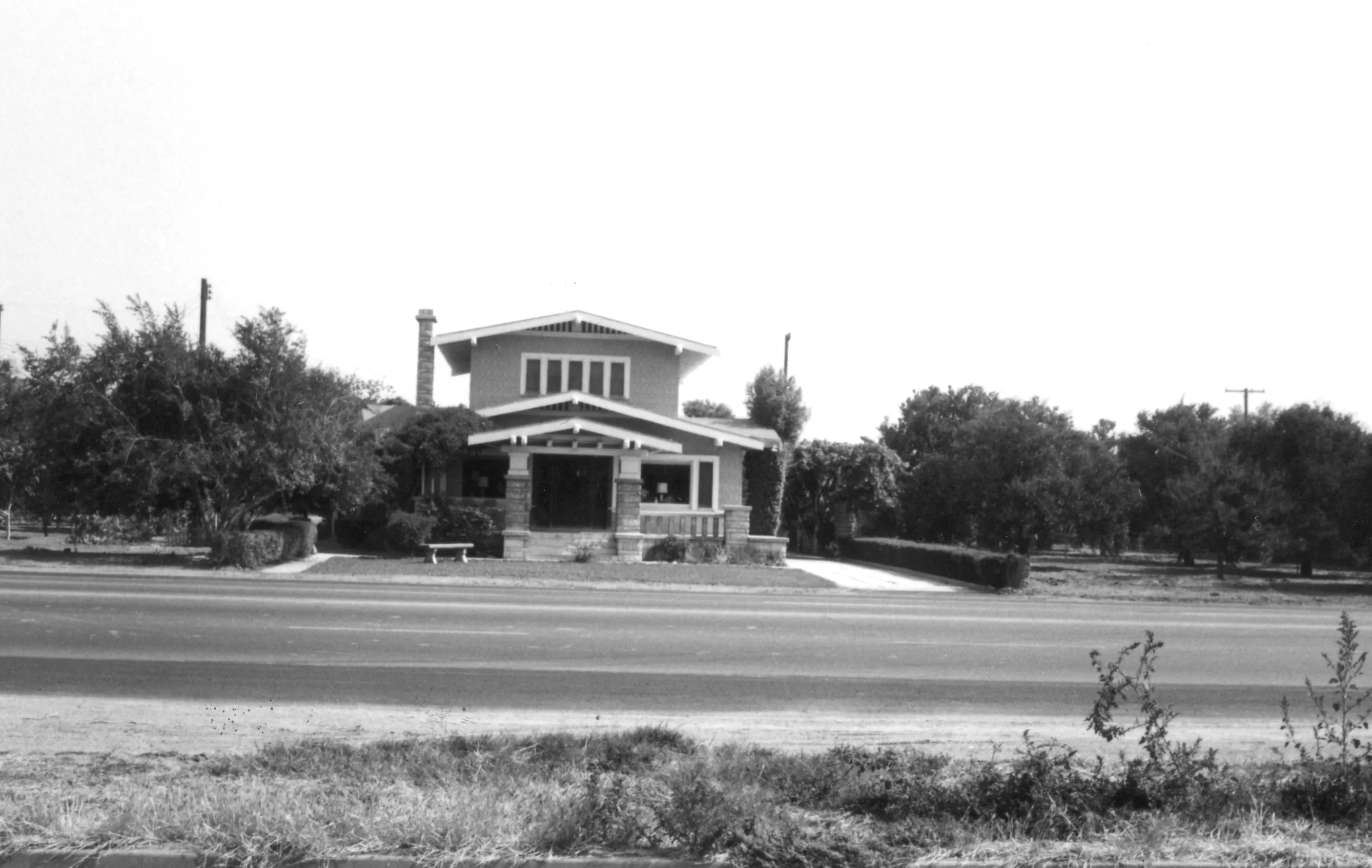 A black and white photograph of the street scene for the Clarence Spencer House in 1967.
