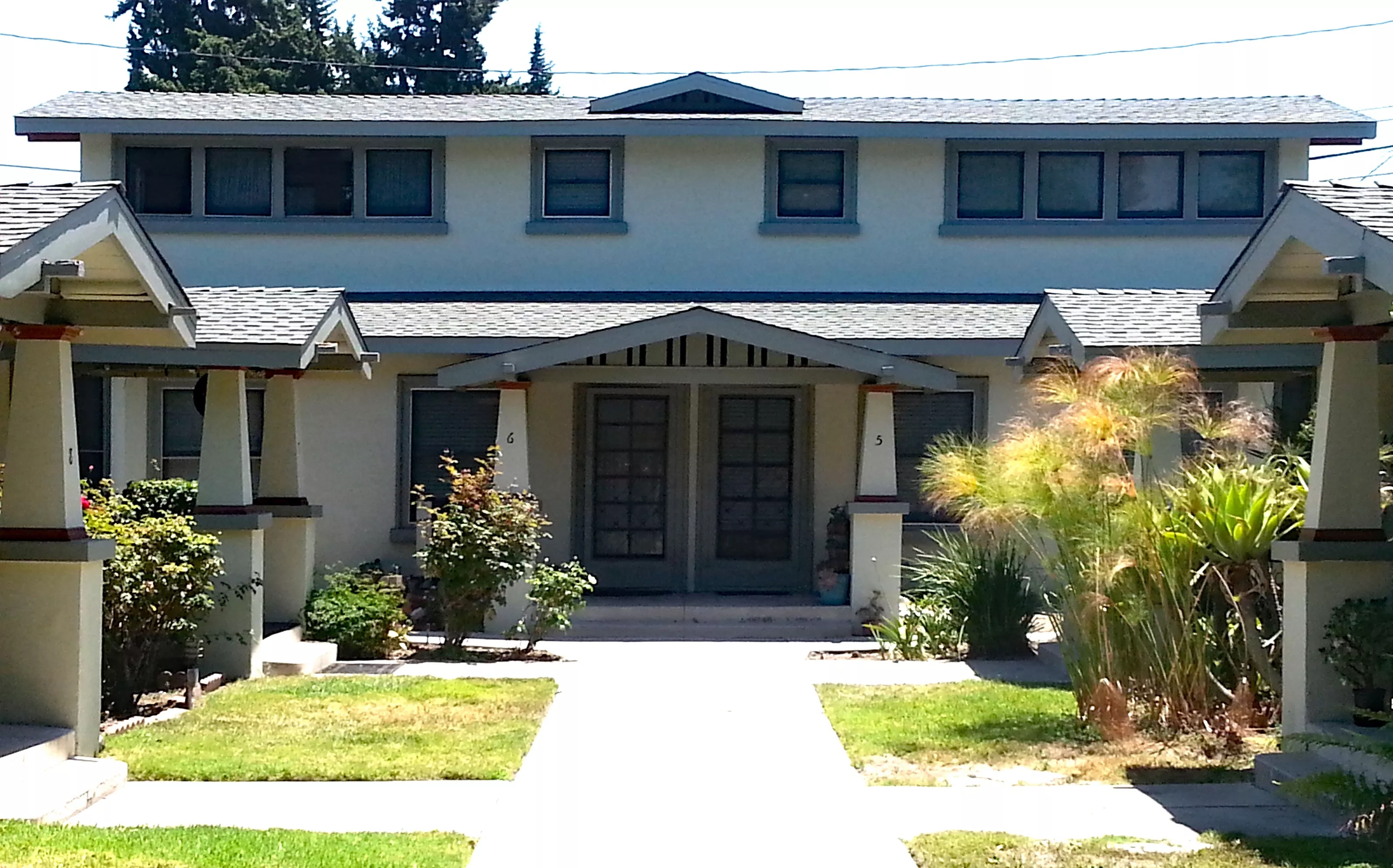 A colored photo of the rear of the two-story Pomona Apartments property in 2017.