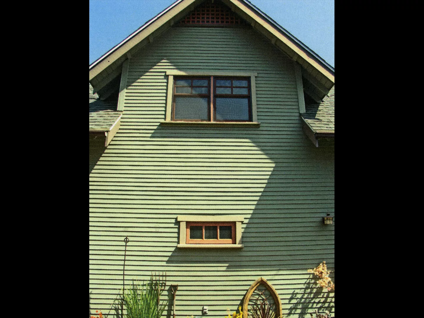A colored photo of the two-story garage and office of the Julius Bradford House in 2013.
