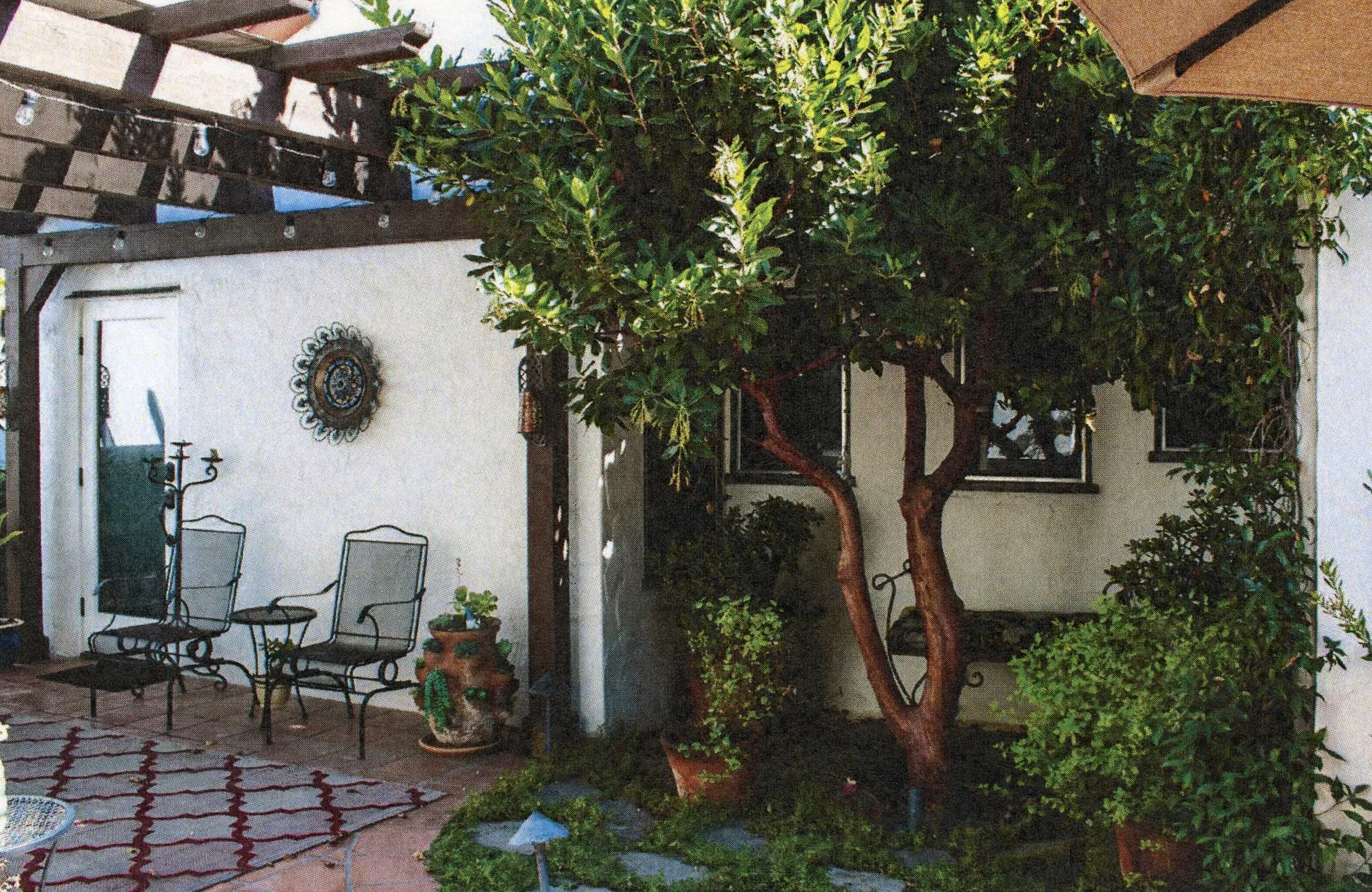 A colored photo of the back patio of the Harry Suters House in 2024.