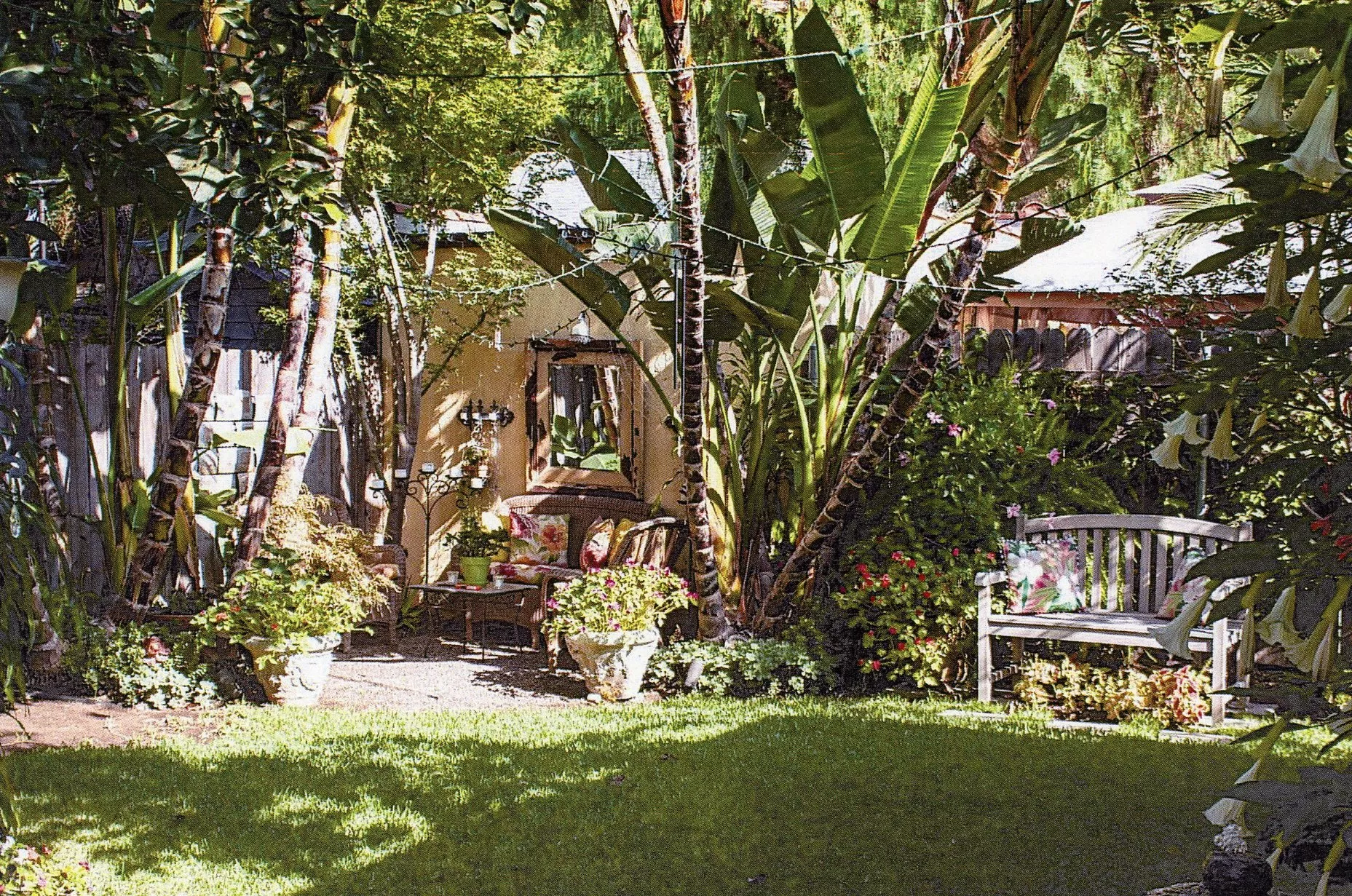 A colored photo of the back yard of the Dell Trook House in 2023.