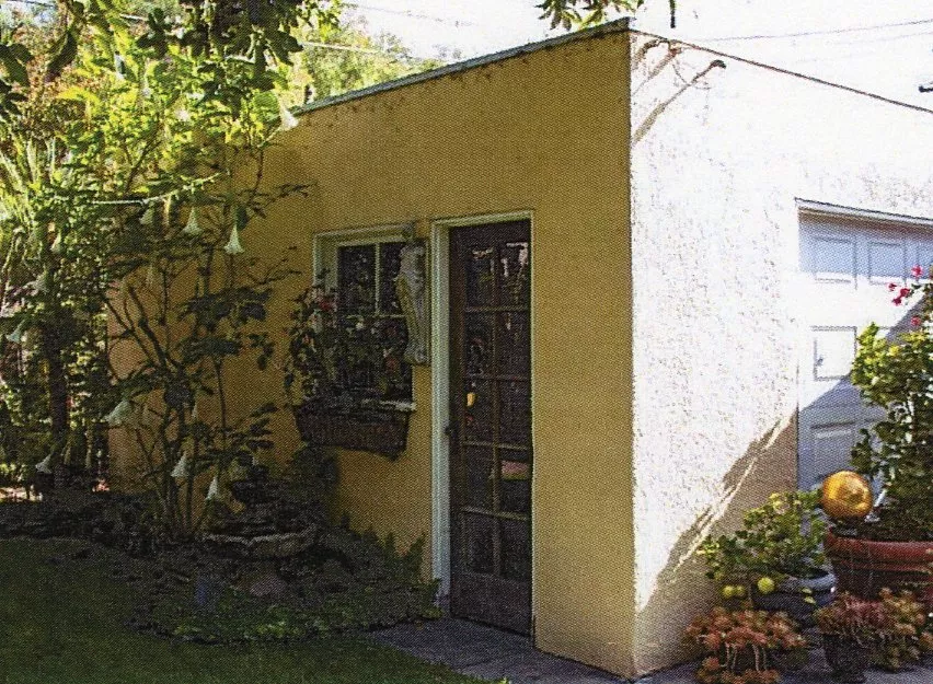 A colored photo of the detached garage of the Dell Trook House in 2023.