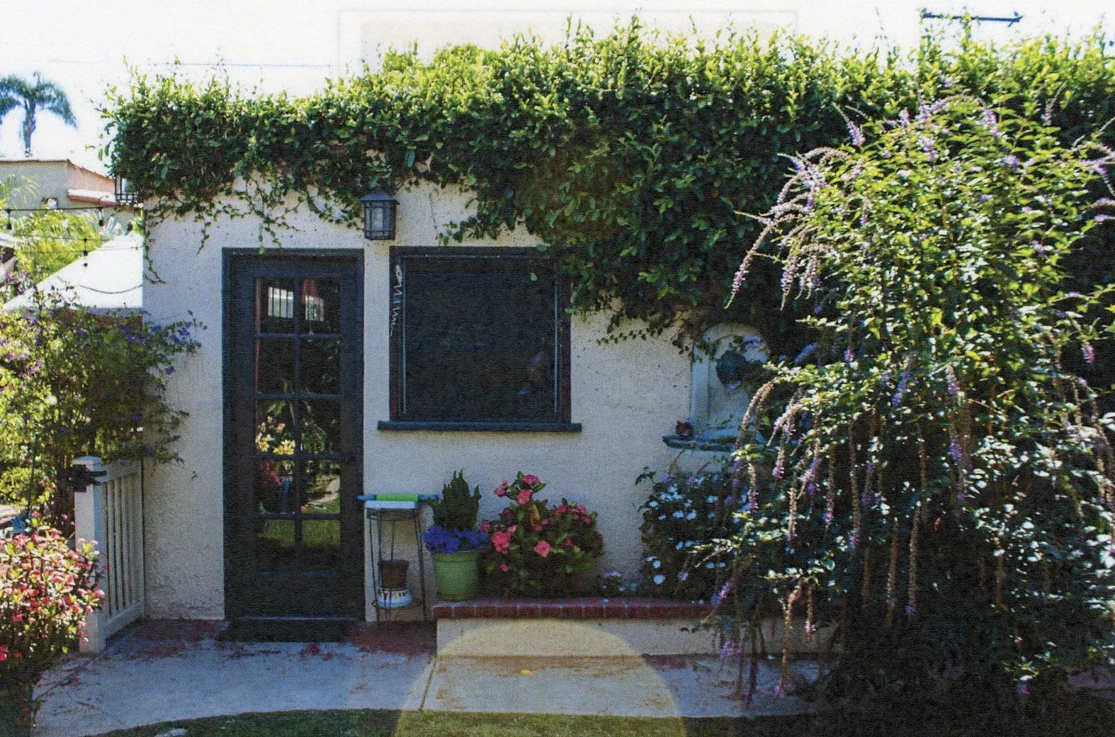 A colored photo of the detached garage of the William N. Rollo House in 2024.