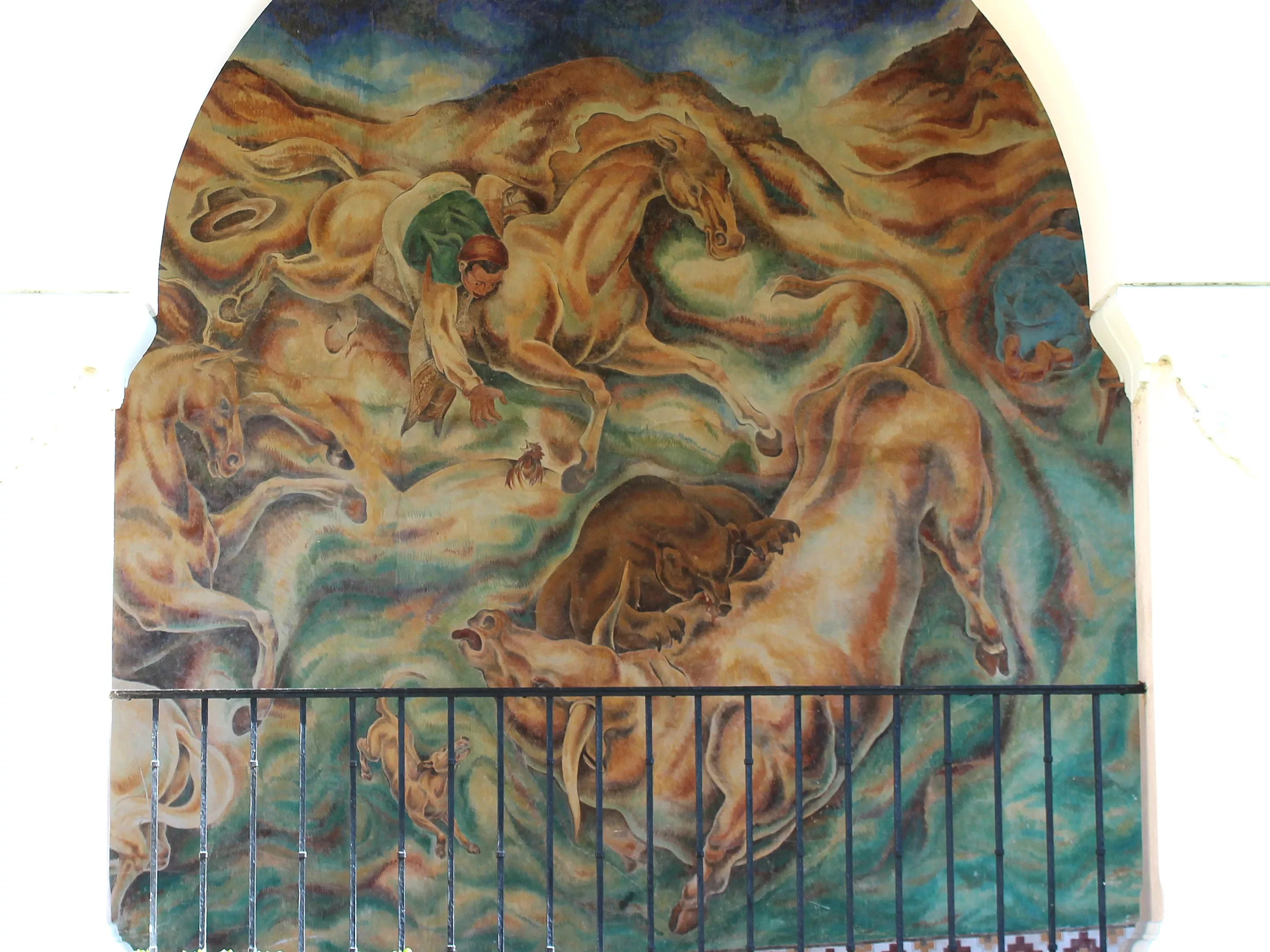 A colored photo of the fresco panel of the &quot;Pastoral California&quot; Mural seen through the arcade in 2021.