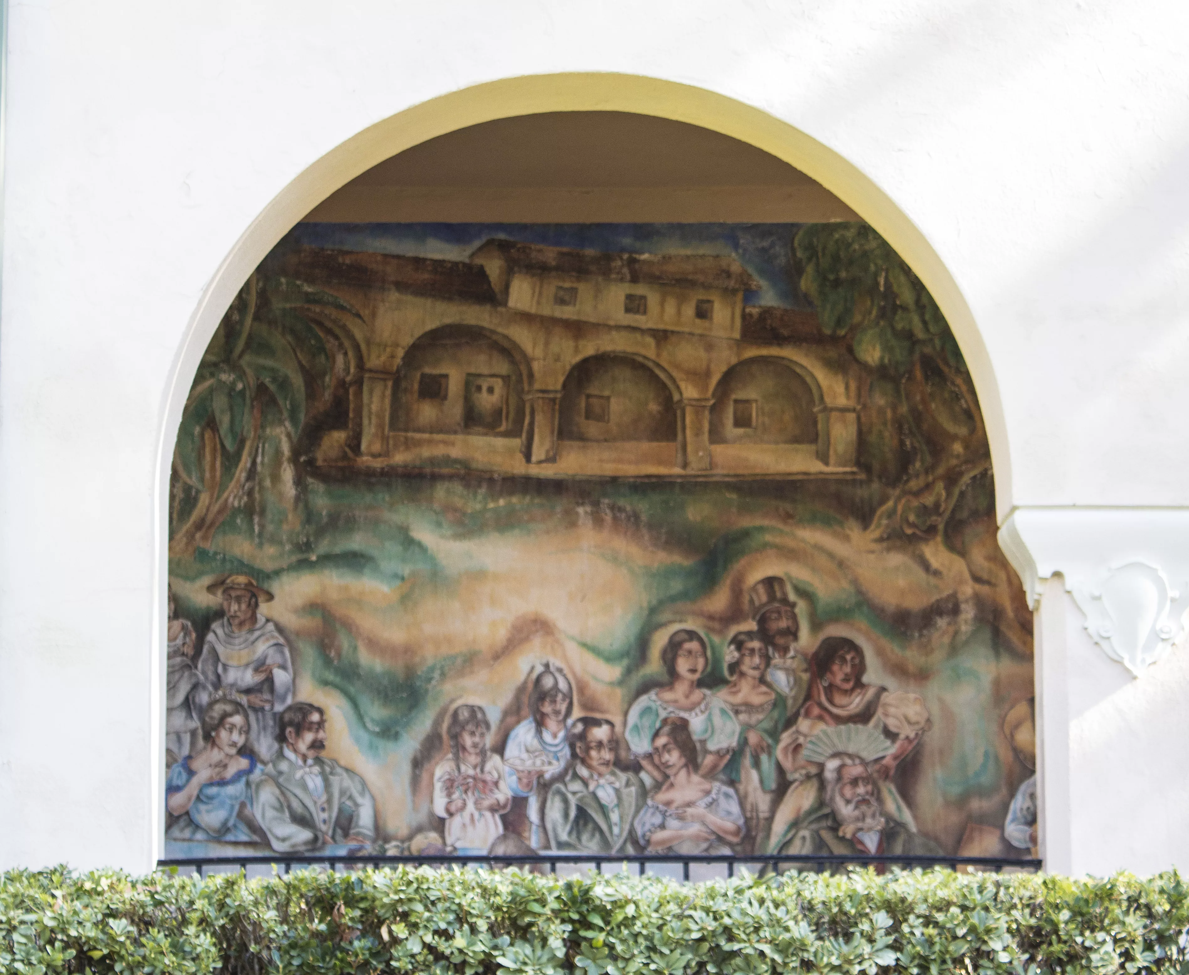 A colored photo of the fresco panel of the &quot;Pastoral California&quot; Mural seen through the arcade in 2021.