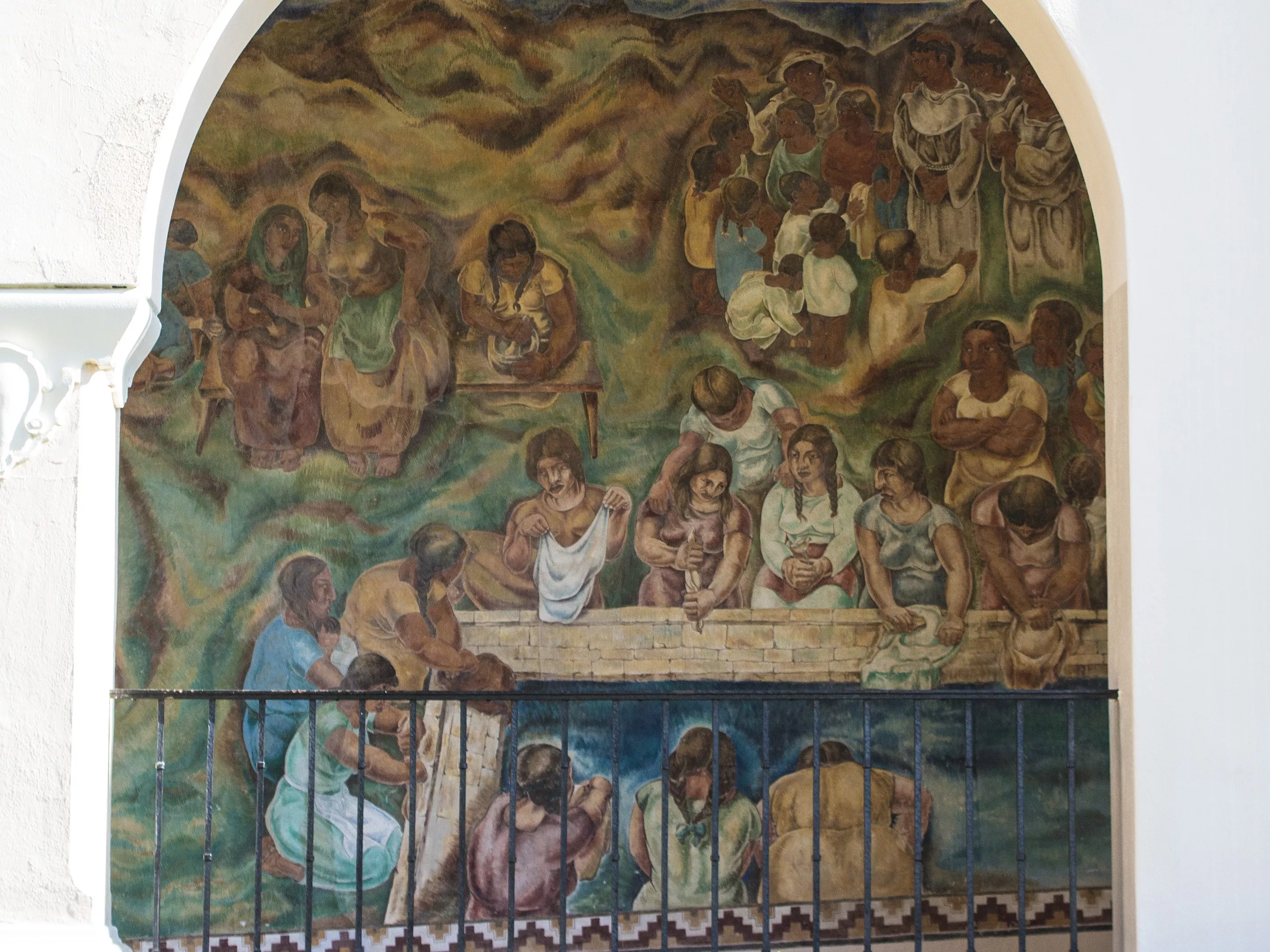 A colored photo of the fresco panel of the &quot;Pastoral California&quot; Mural seen through the arcade in 2021.