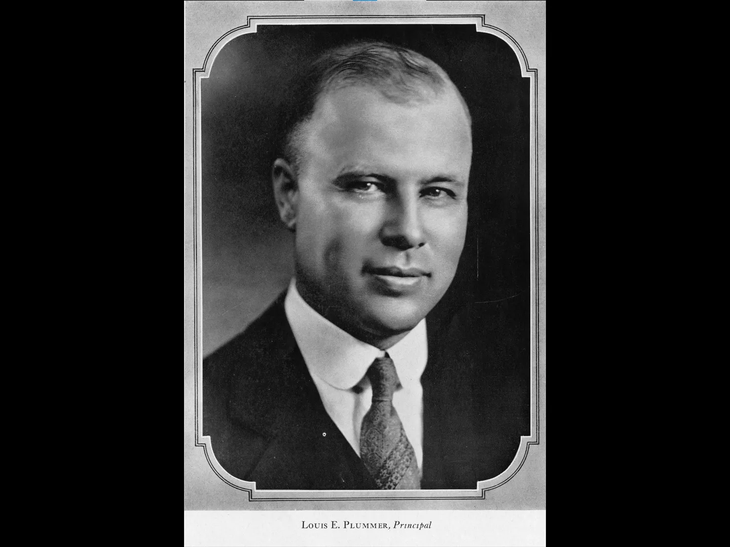 A black and white portrait photograph of Louis Plummer in 1929. The bottom of the photo reads: Louis E. Plummer, Principal.