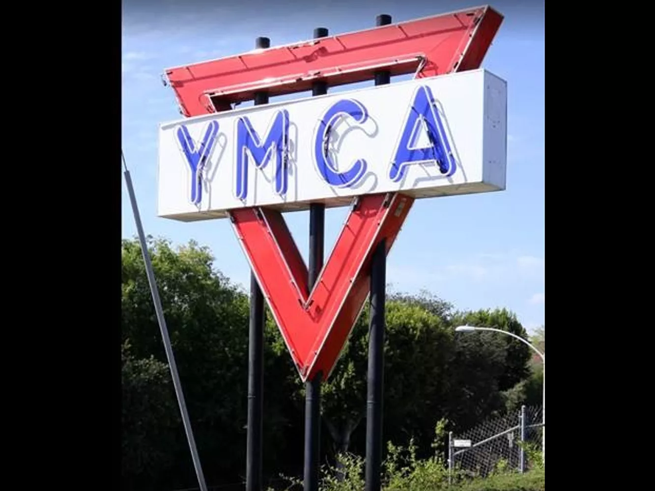 A colored photo of the YMCA neon sign during the day in 2019.