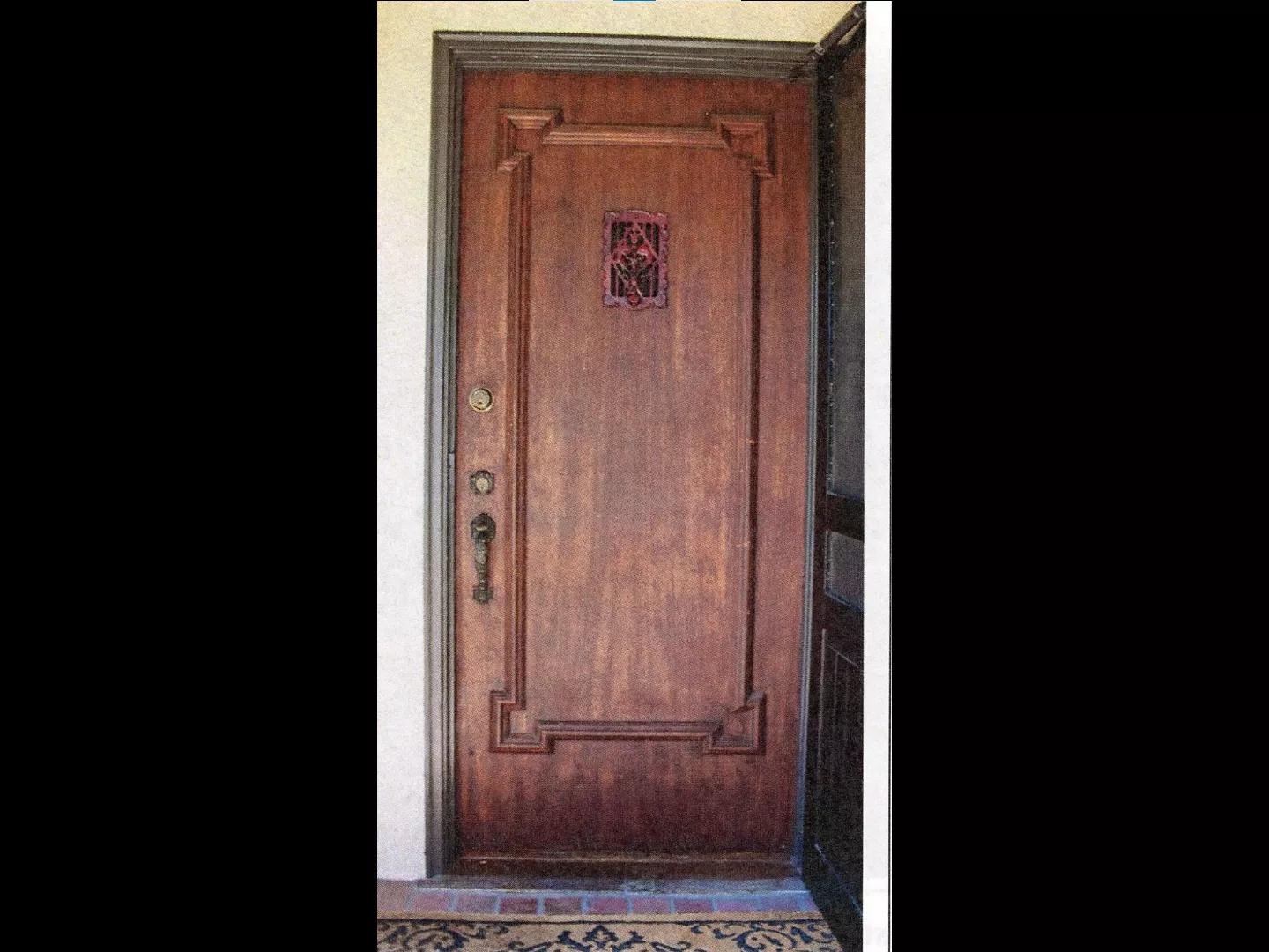 A colored photo of the original front door of the William N. Rollo House in 2024.