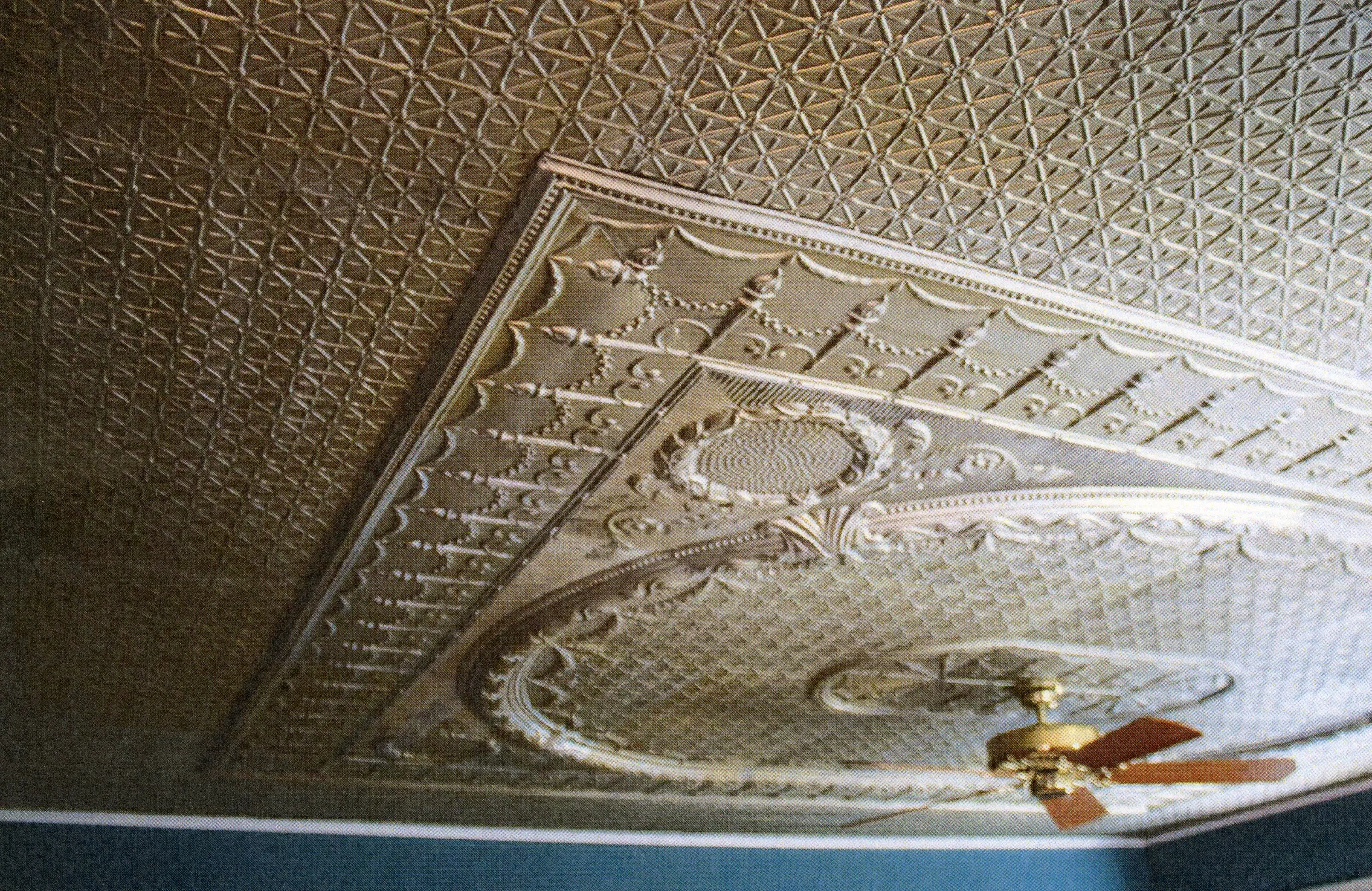 A colored photo of the original tin ceiling inside the James Naylor - Tom &amp; Kate Dalton House in 2019.
