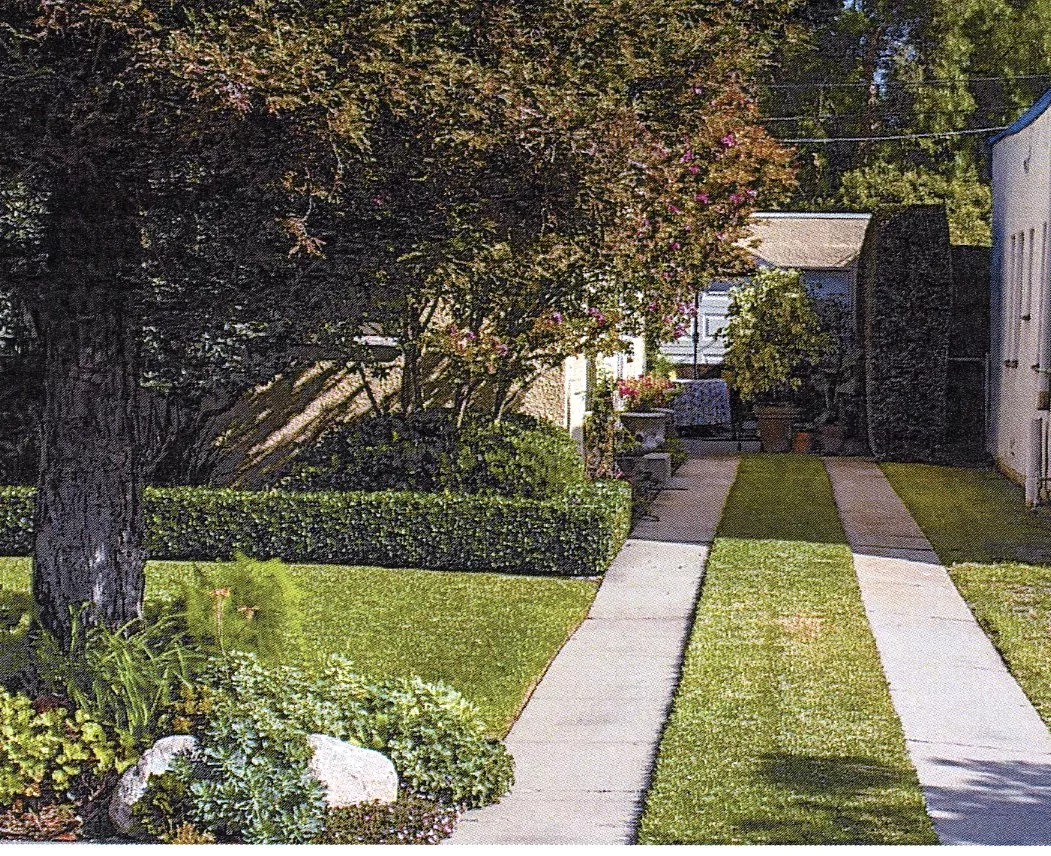 A colored photo of the ribbon driveway of the Dell Trook House in 2023.