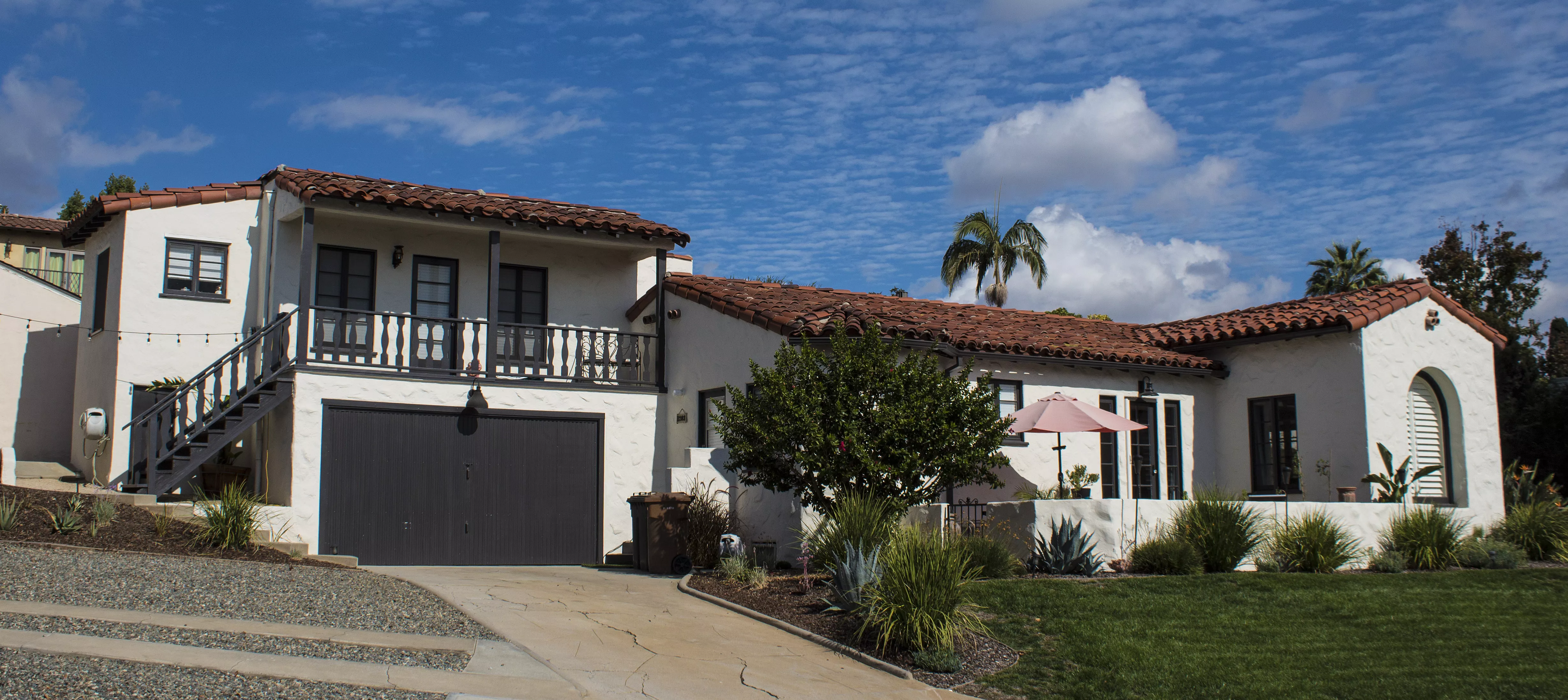 A colored photo of the street scene for the Otto Evans House in 2024.