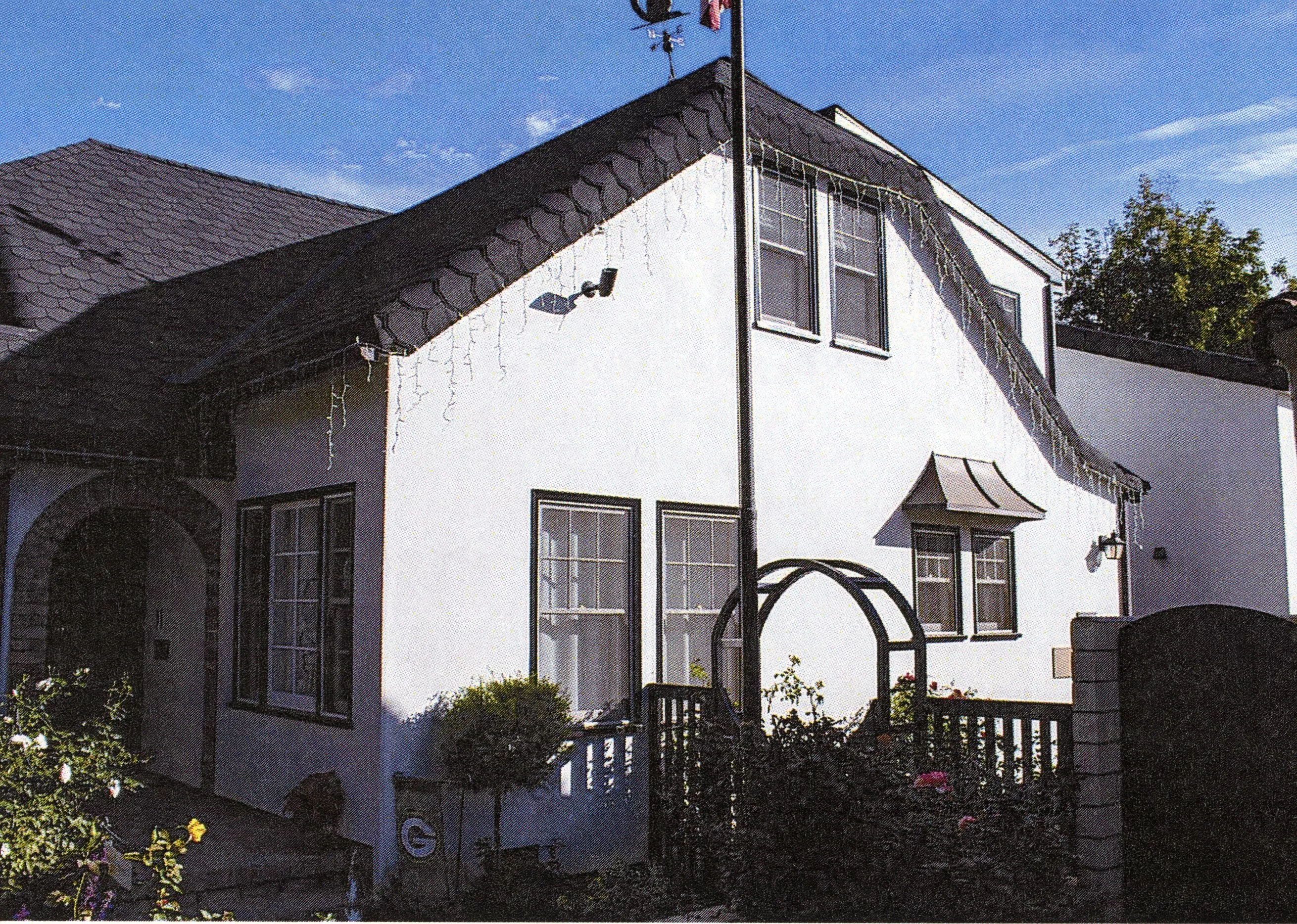 A colored photo of the west side exterior of the Earl Dysinger - Charles Schugt House in 2023.