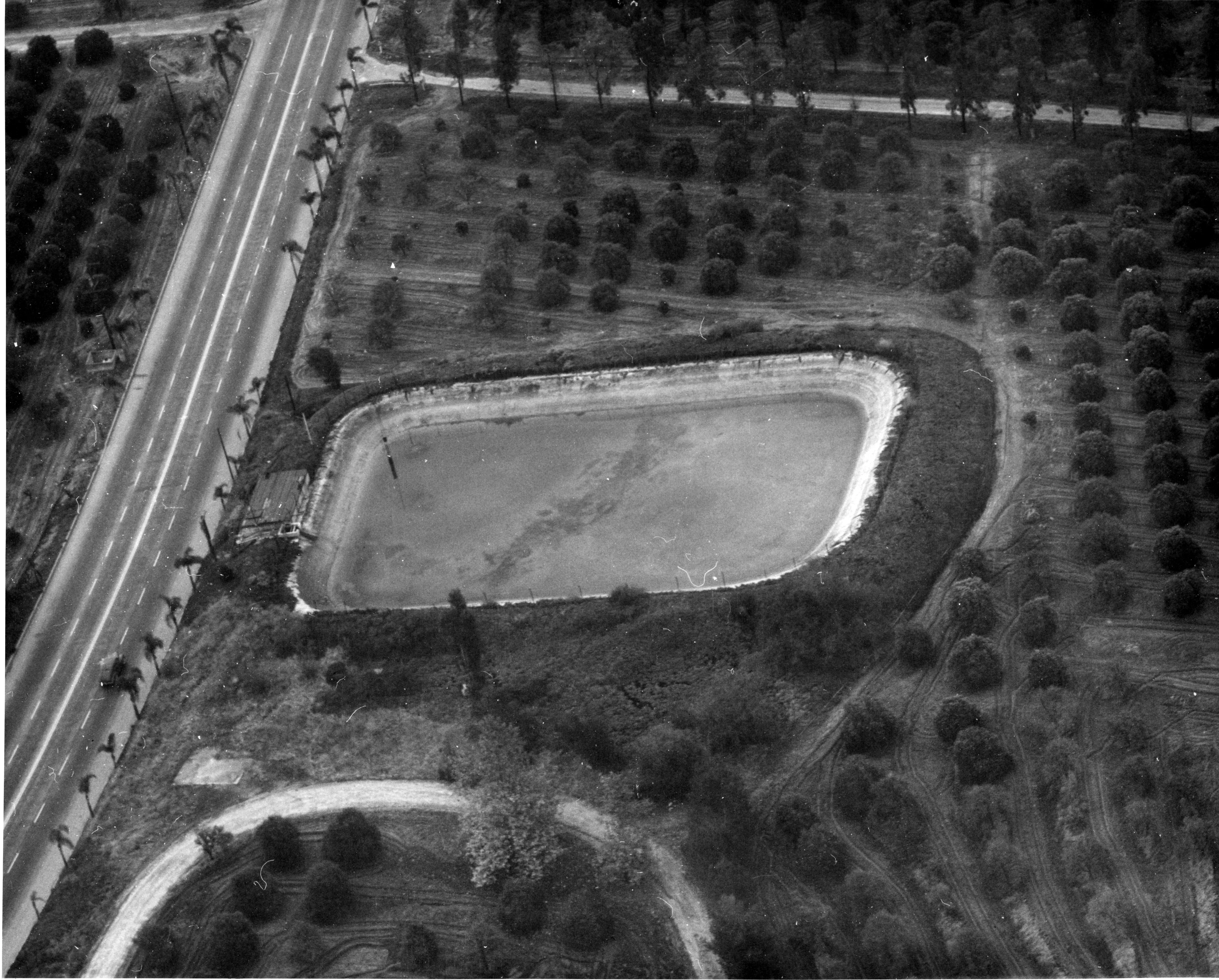 A digital scan of an aerial view of the Bastanchury Ranch Reservoir in 1952.