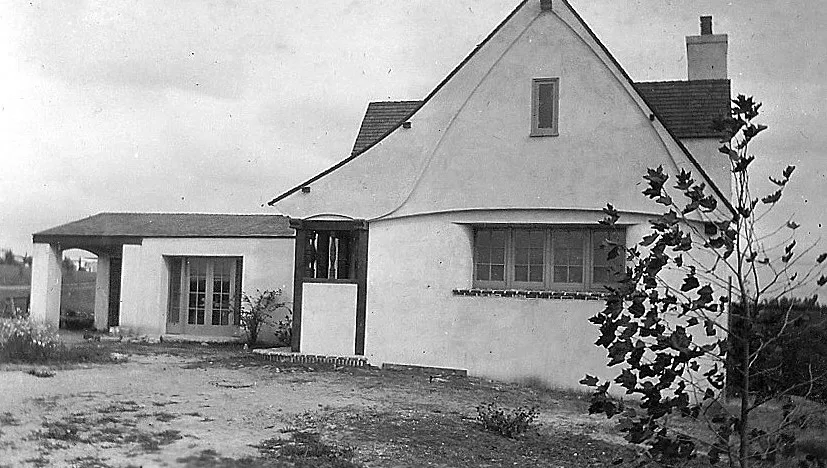 A black and white photograph of the front view of the Raymond Starbuck House.