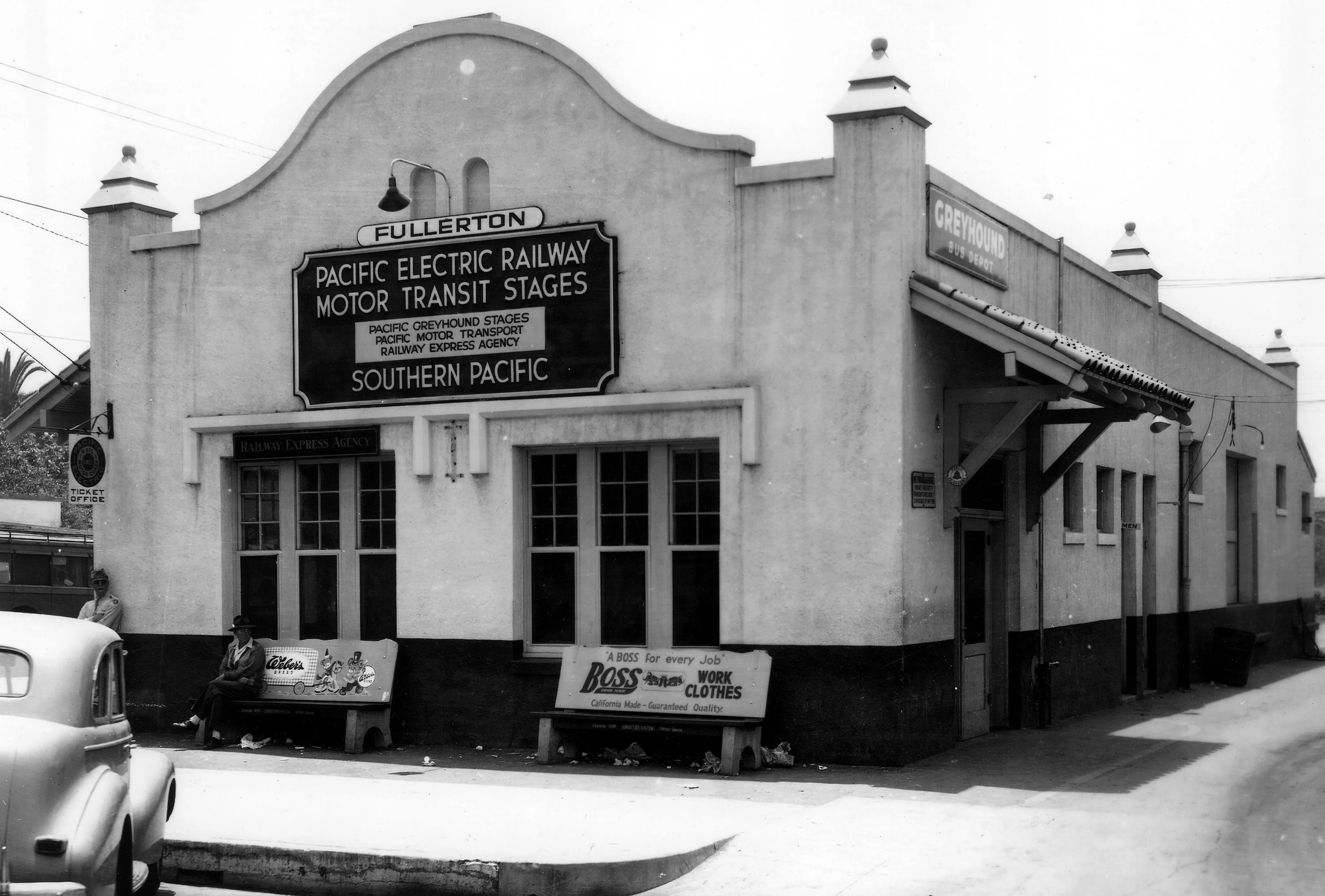 A black and white photograph of the Pacific Electric Depot being used for Pacific Electric and Greyhound Service.