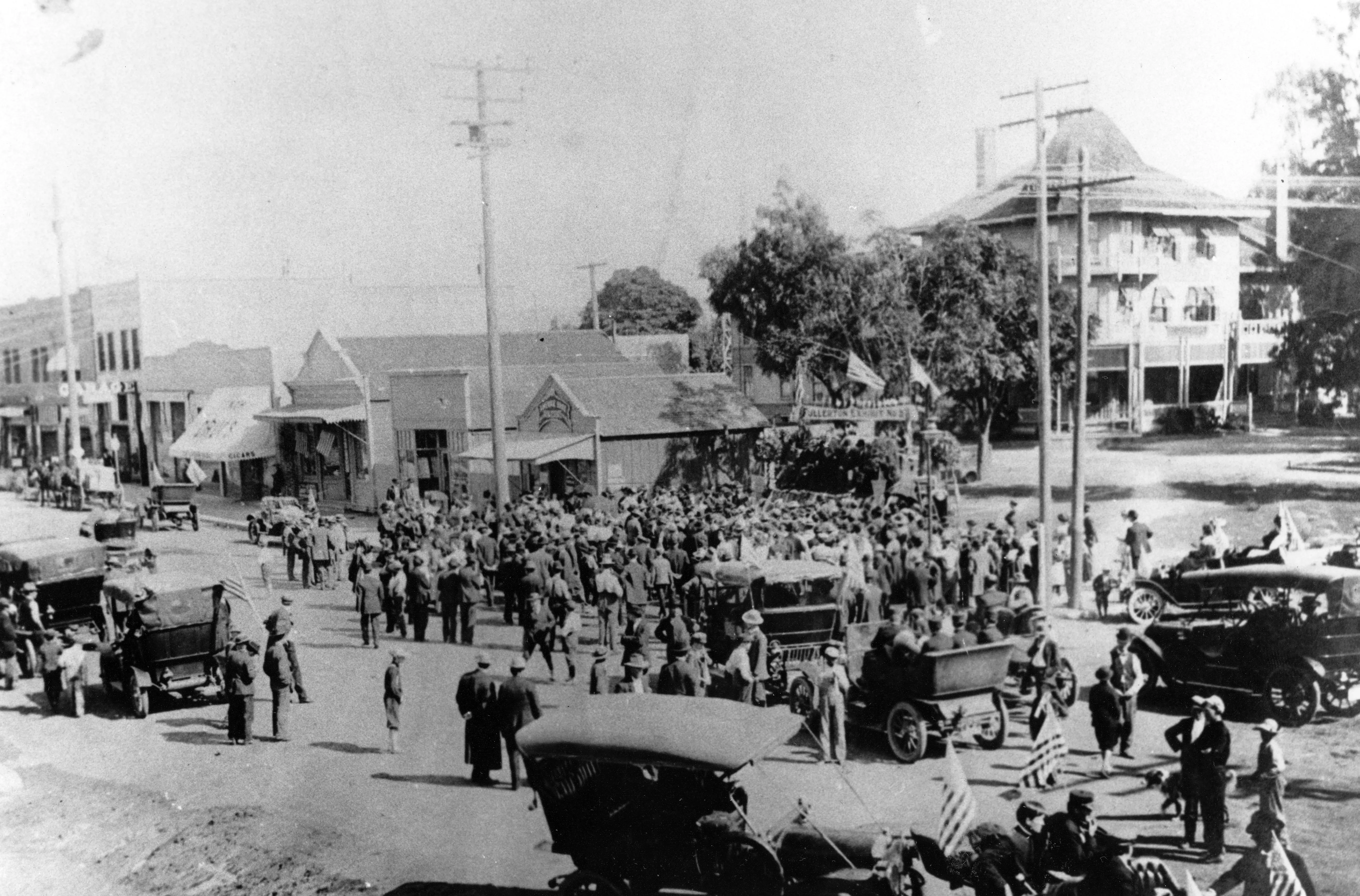 A black and white photograph of a busy street scene with the Amerige Office in the center.