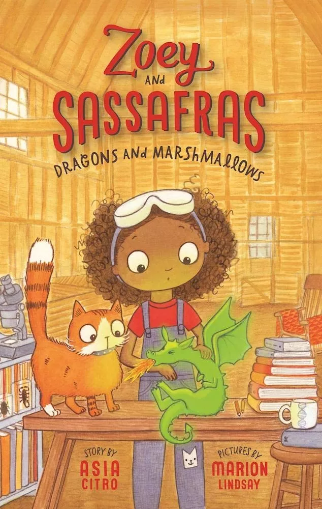 Cover of Dragons and Marshmallows by Asia Citro depicting a brown skinned girl wearing a red shirt and denim overalls with safety goggles on her head. There is an orange cat and a green dragon on the table in front of her.