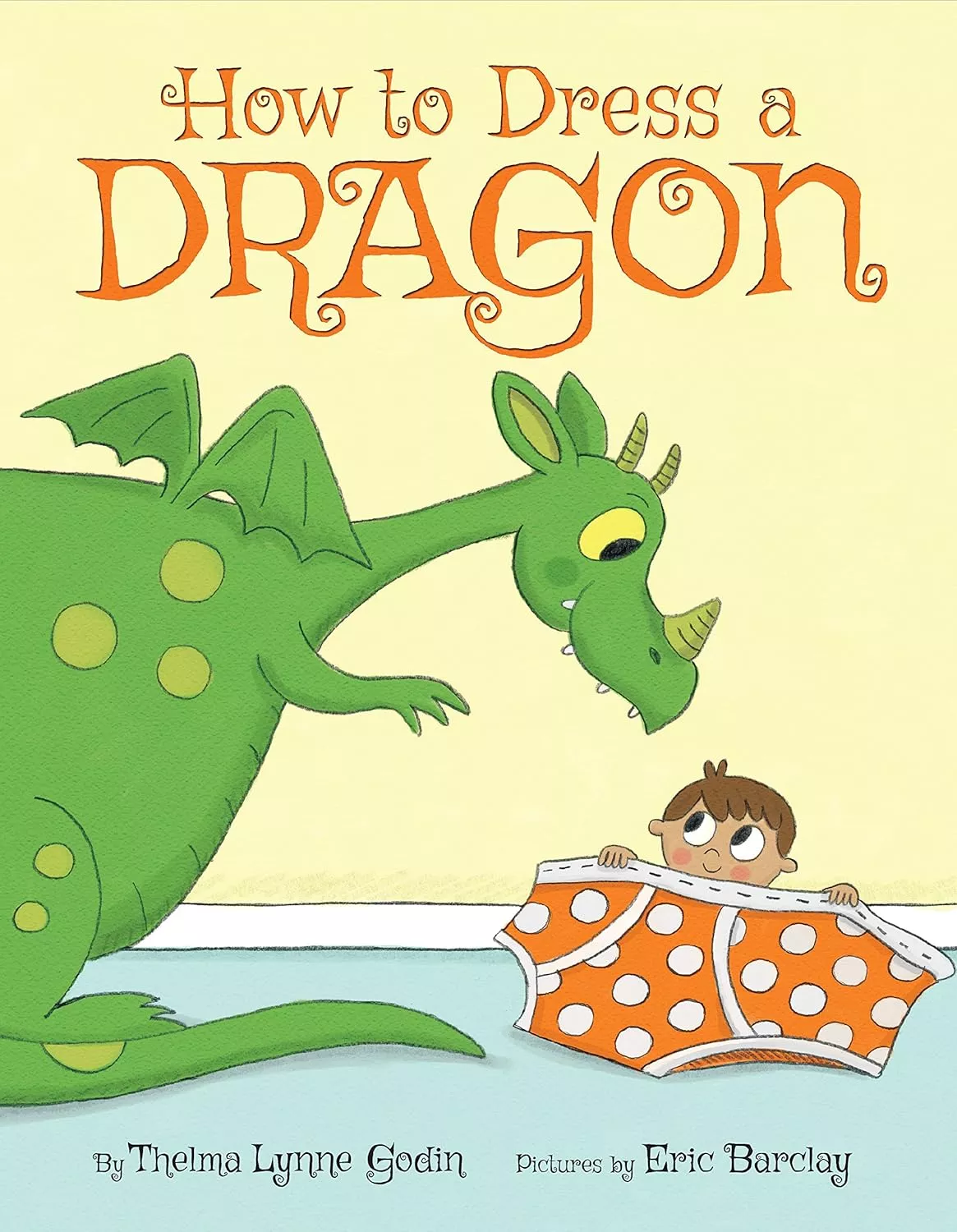 Cover of How to Dress a Dragon by Thelma Lynne Godin depicting a illustrated dragon looking at a boy hiding behind a giant pair of red underwear with white polka dots.